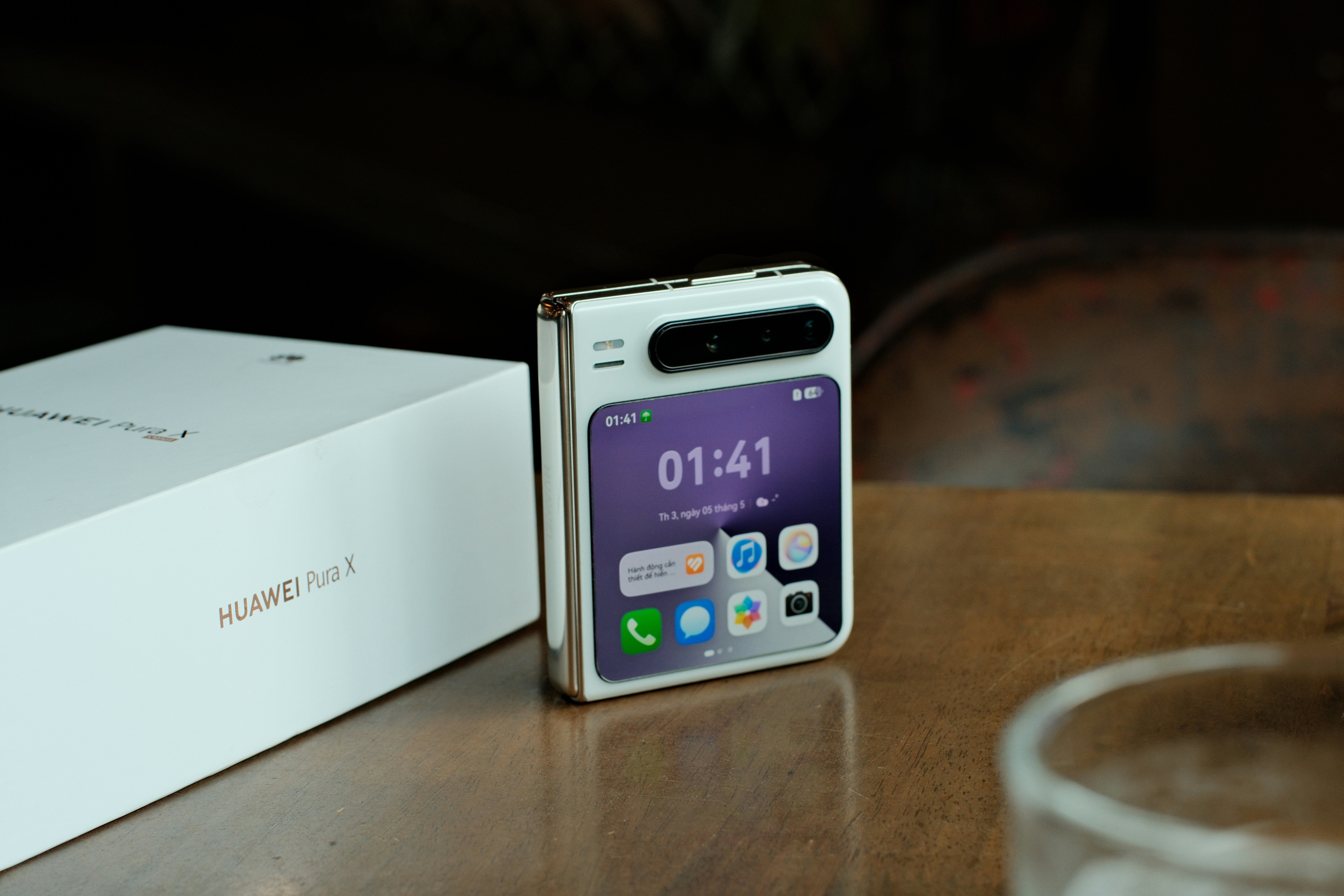 A white foldable smartphone with purple screen display.