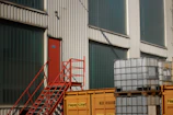 Industrial building with red stairs and storage tanks