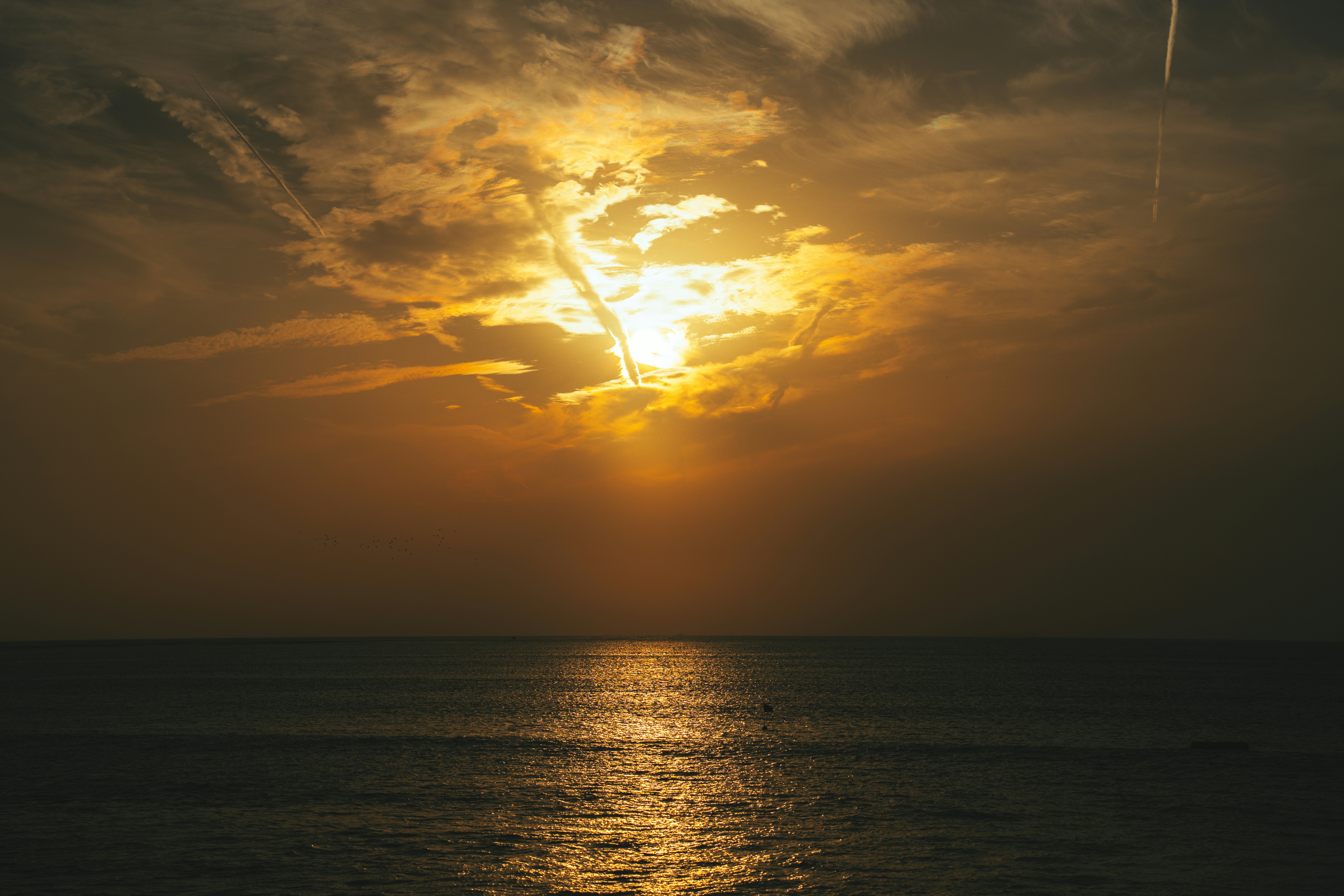 Golden sun setting over a calm ocean