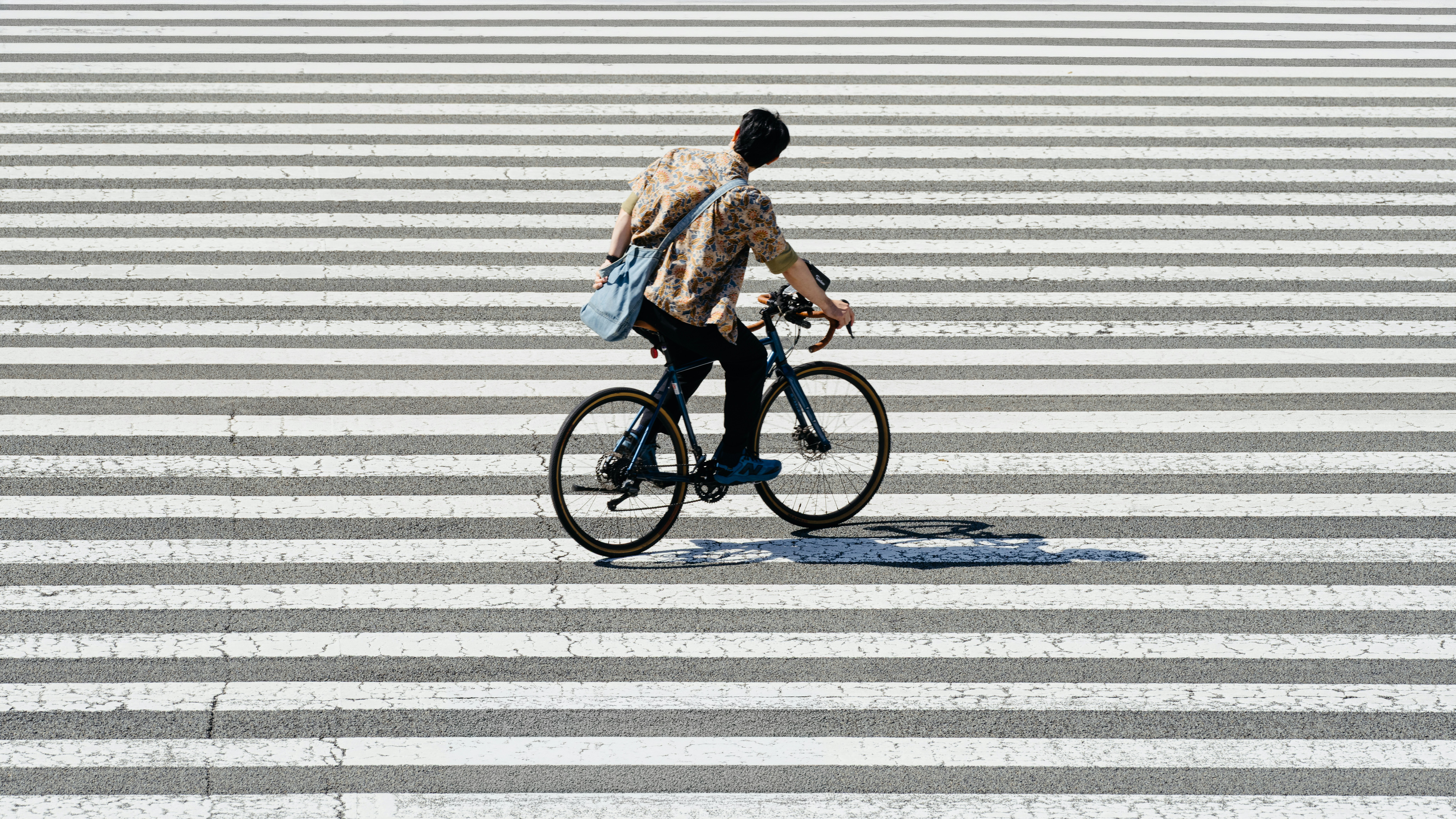 Person riding a bicycle on a crosswalk