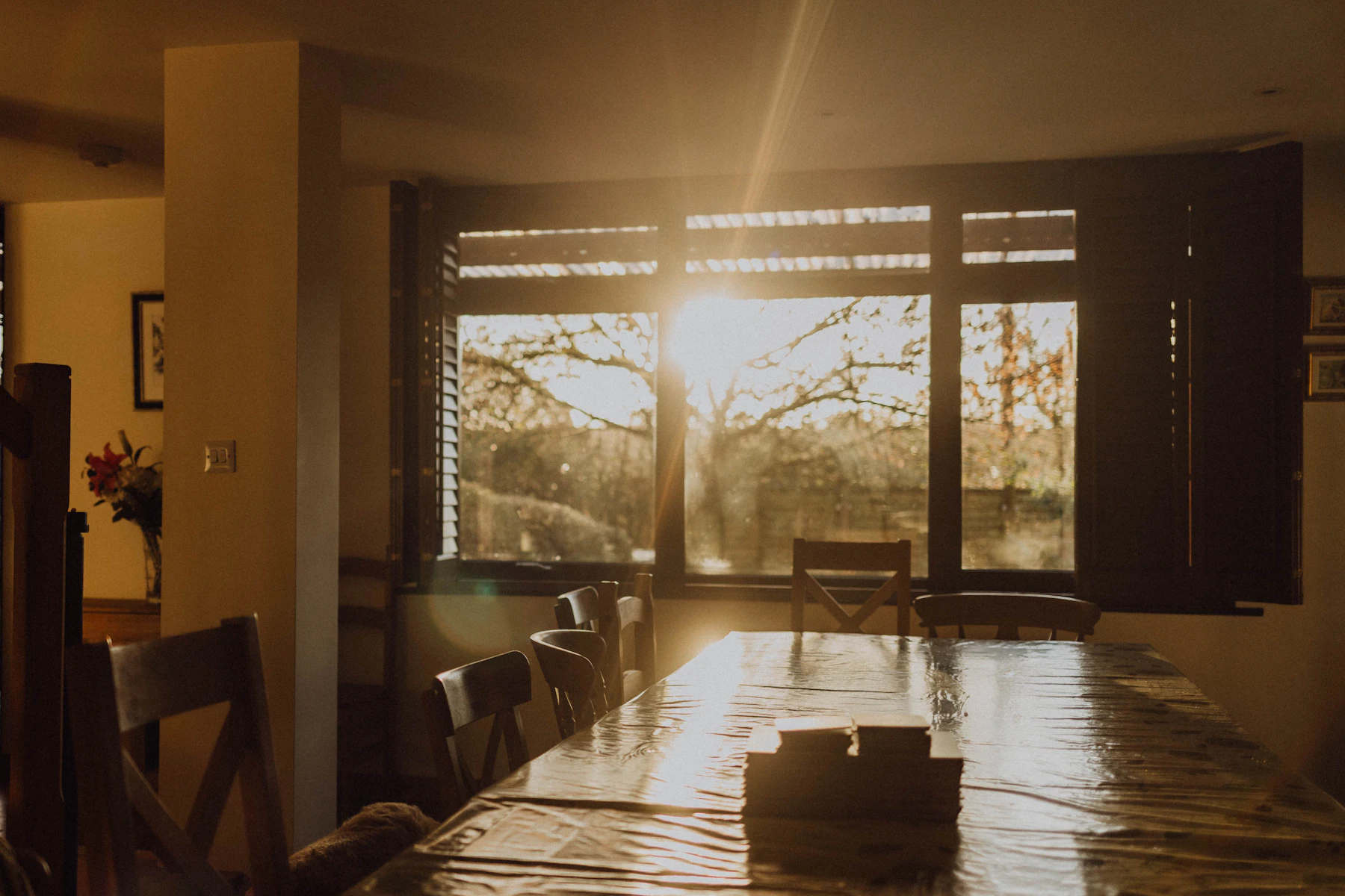 Warm dining room with a table illuminated by natural sunlight