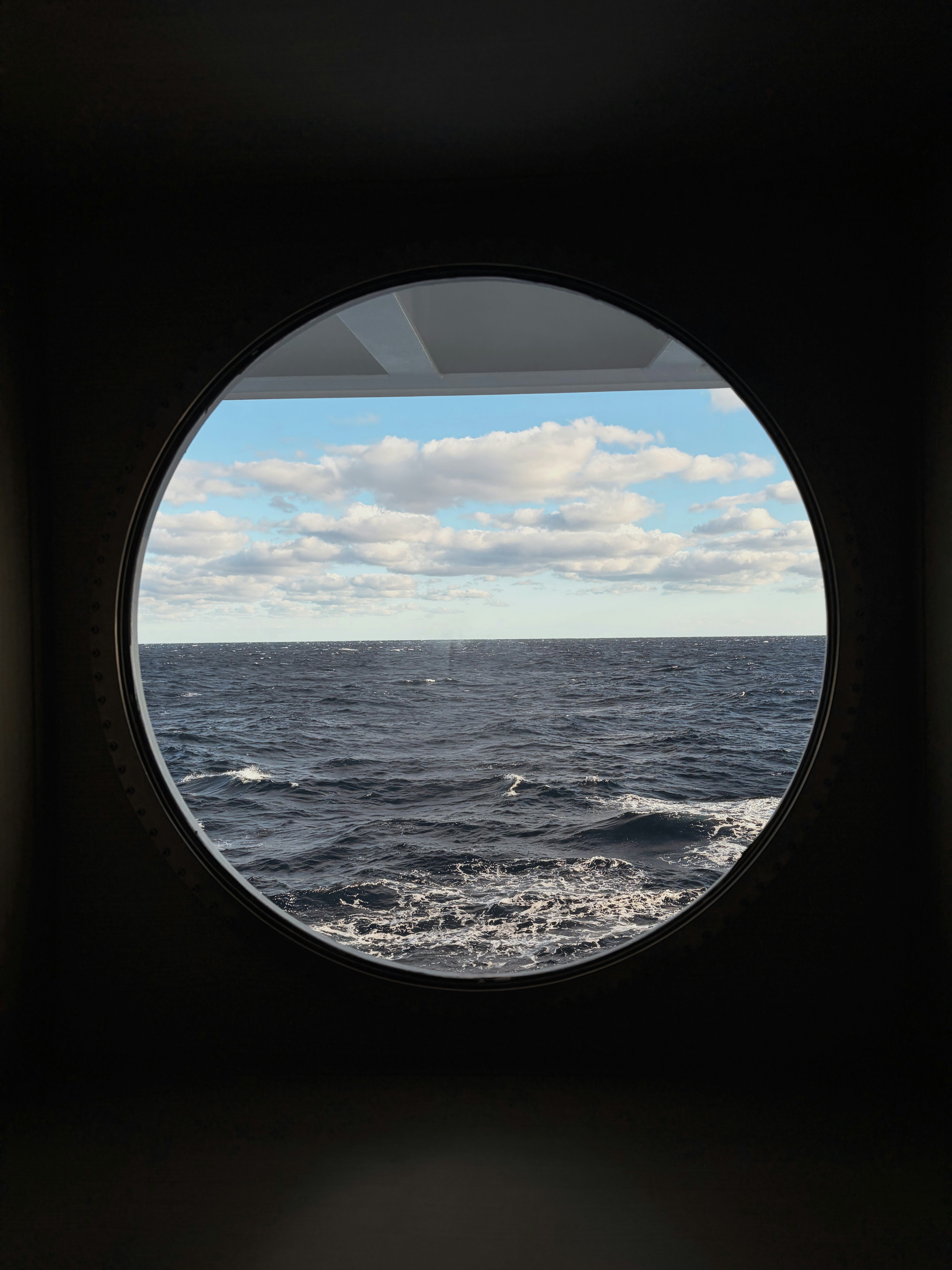View of the ocean from a circular window.