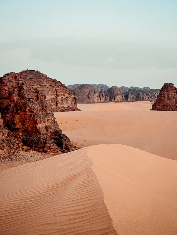Vast desert landscape with sand dunes and rock formations admer tour Djanet Algeria