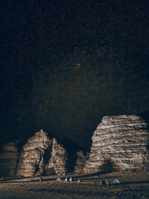 Tents under the stars surrounded by mountains in the Sahara Desert of Djanet, Algeria