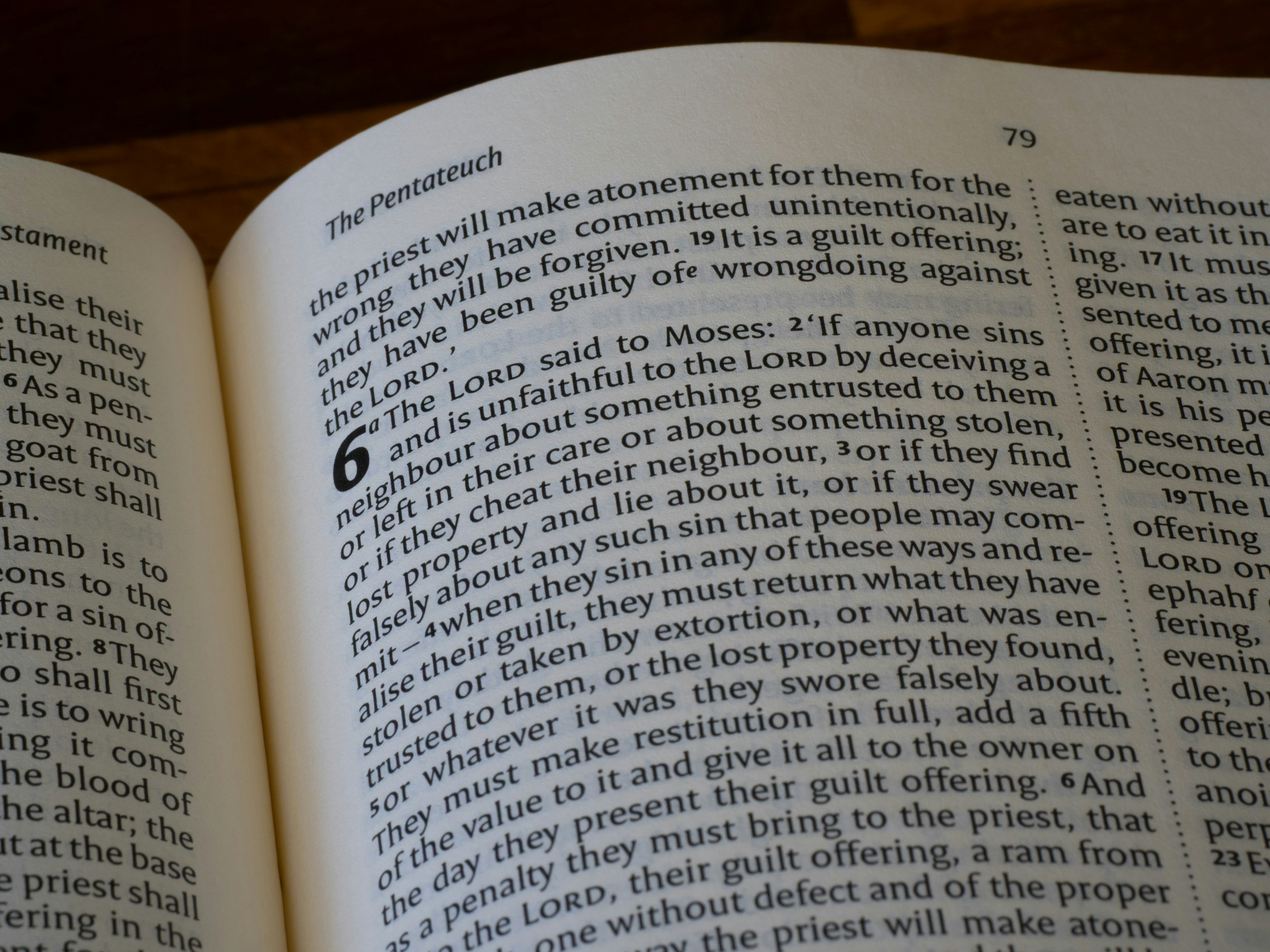 Close-up of an open bible with text visible.