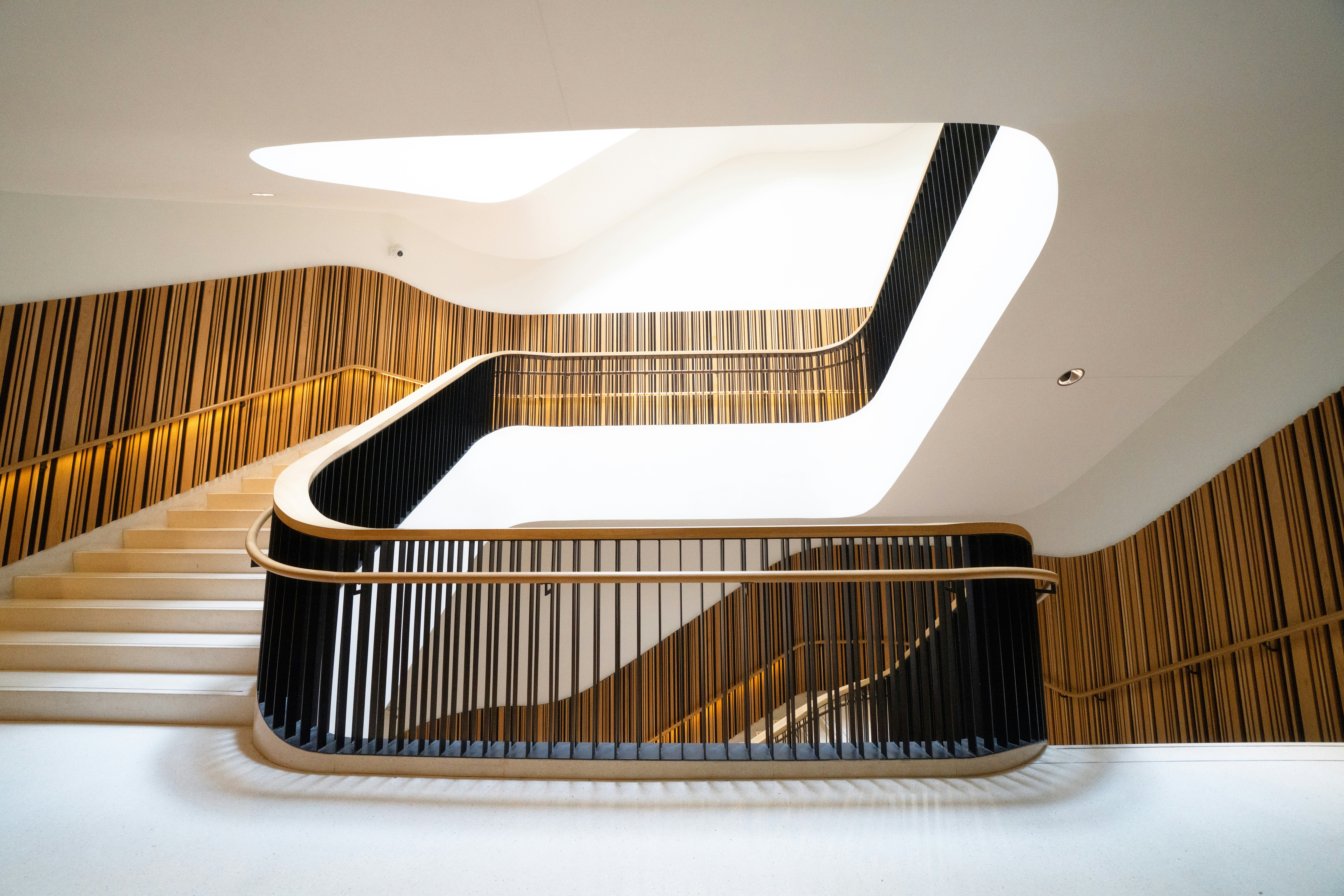Modern staircase with wooden accents and black railings