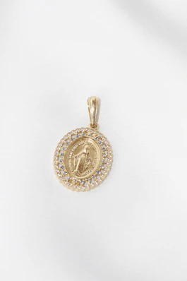 Gold oval pendant with virgin mary and diamonds