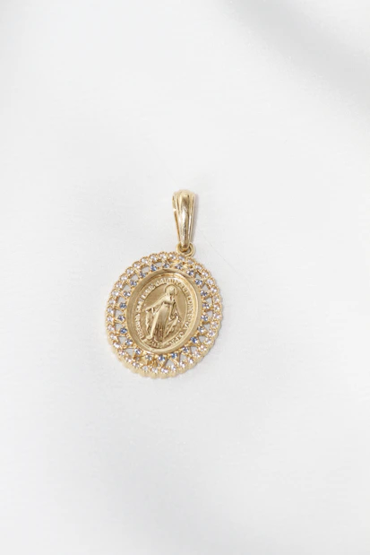 Gold oval pendant with virgin mary and diamonds