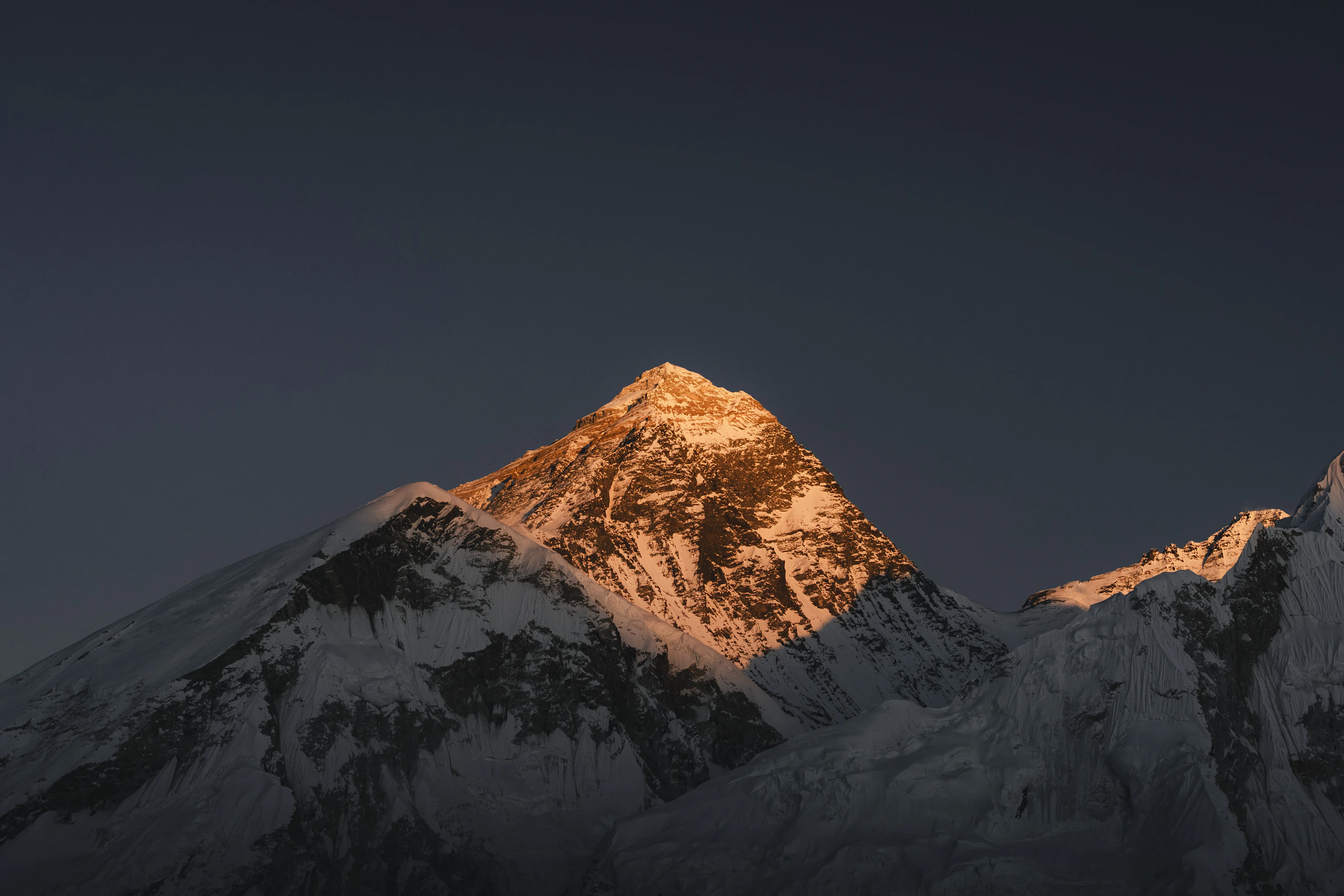 Mount Everest glowing in golden first light at sunrise, Khumbu, Nepal