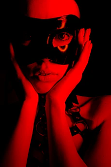 Person wearing a black mask with red lighting