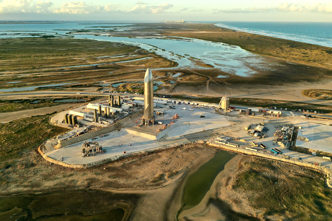 Rocket launchpad with tall rocket and surrounding structures