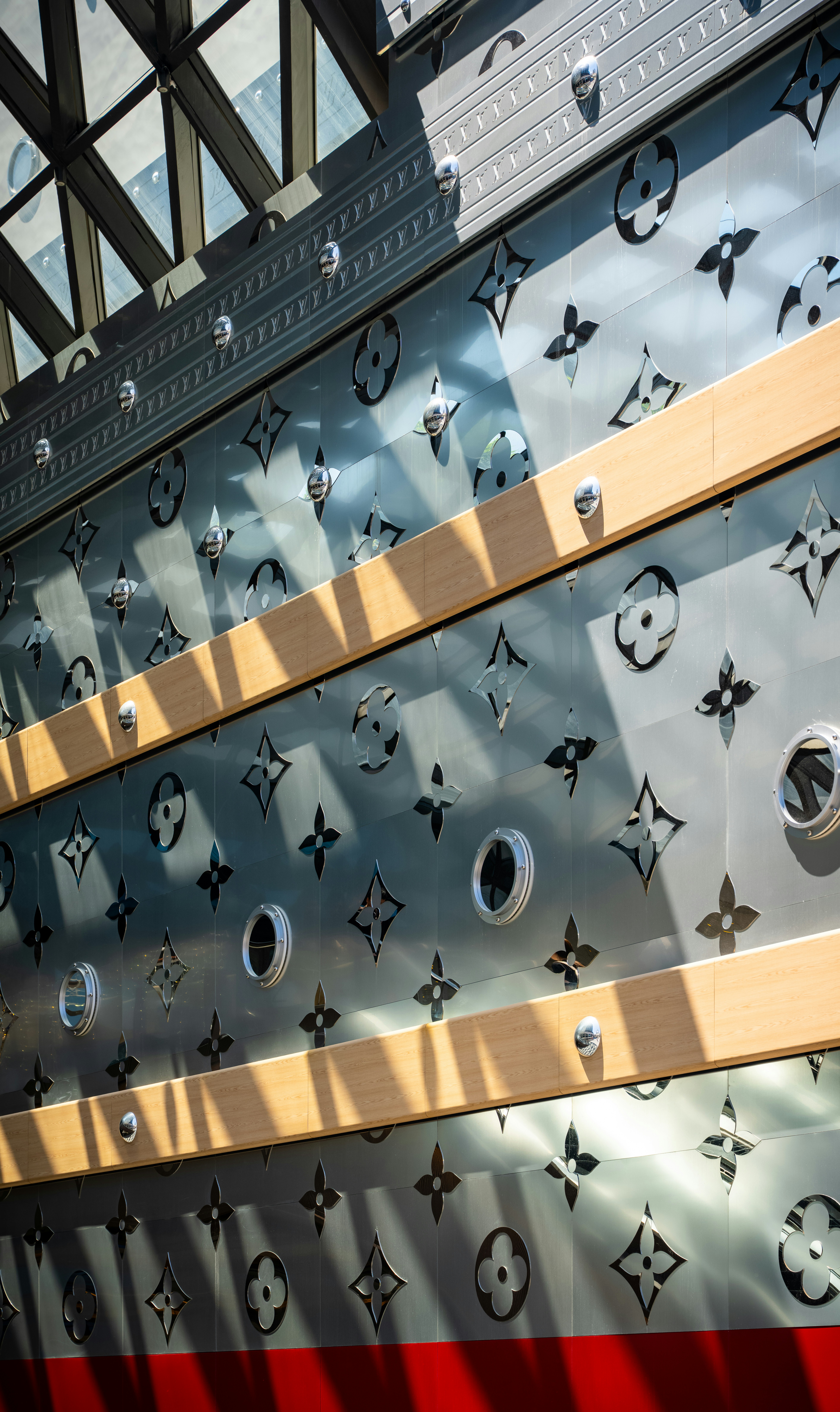 Pared metálica con patrón repetitivo de monogramas Louis Vuitton