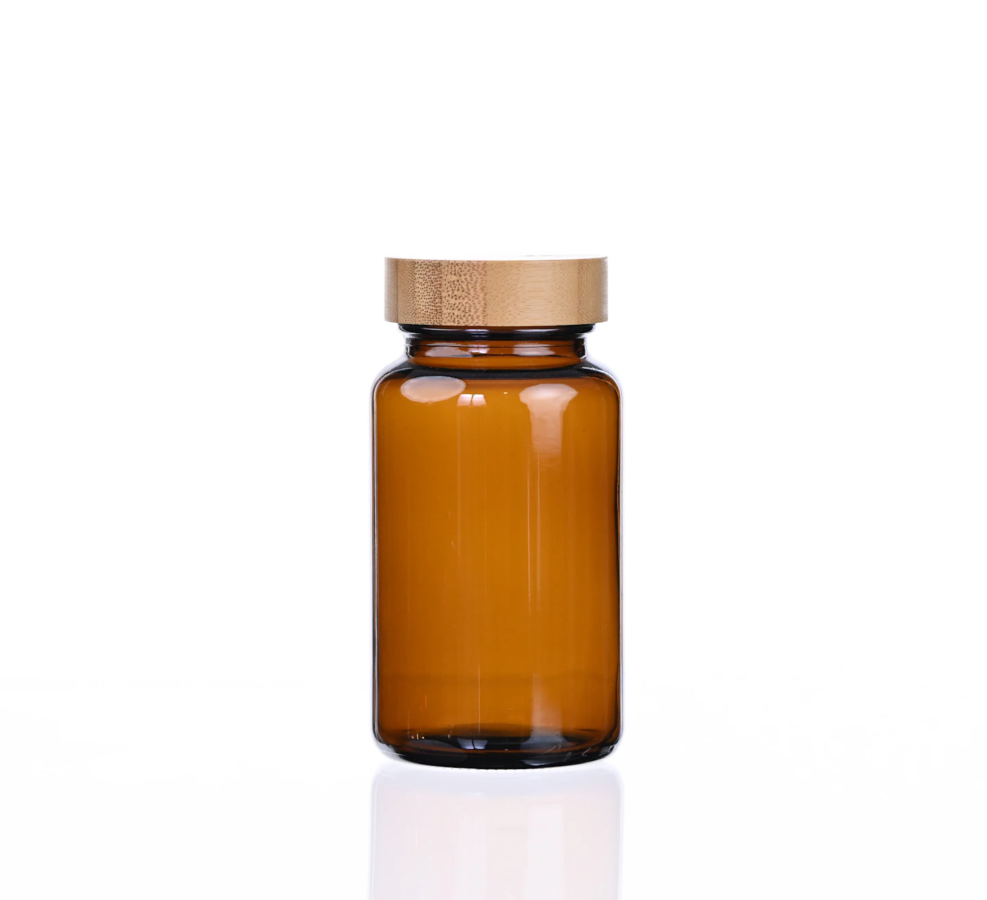 An amber glass bottle with a wooden lid