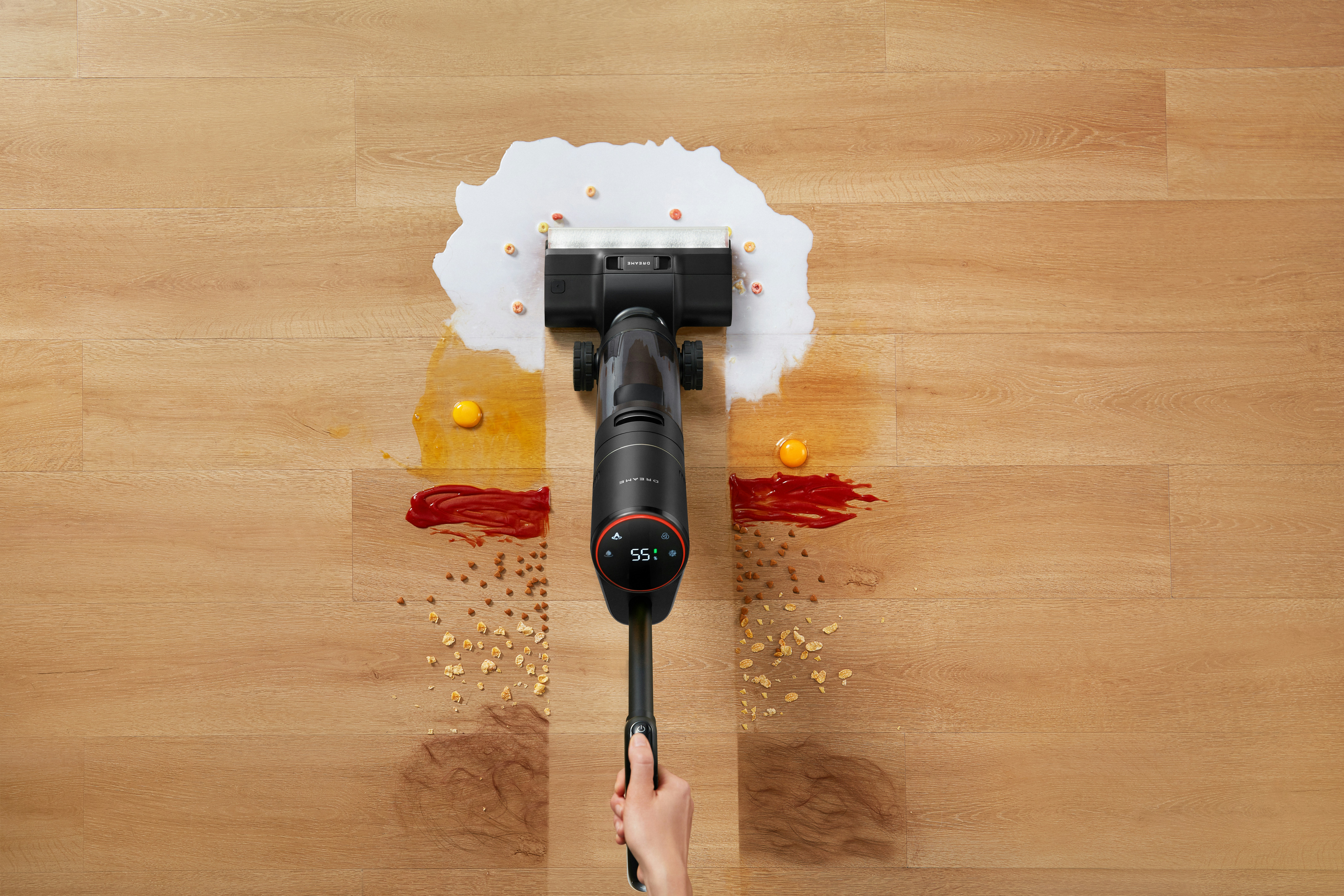 Vacuum cleaner cleaning up spills on a wooden floor