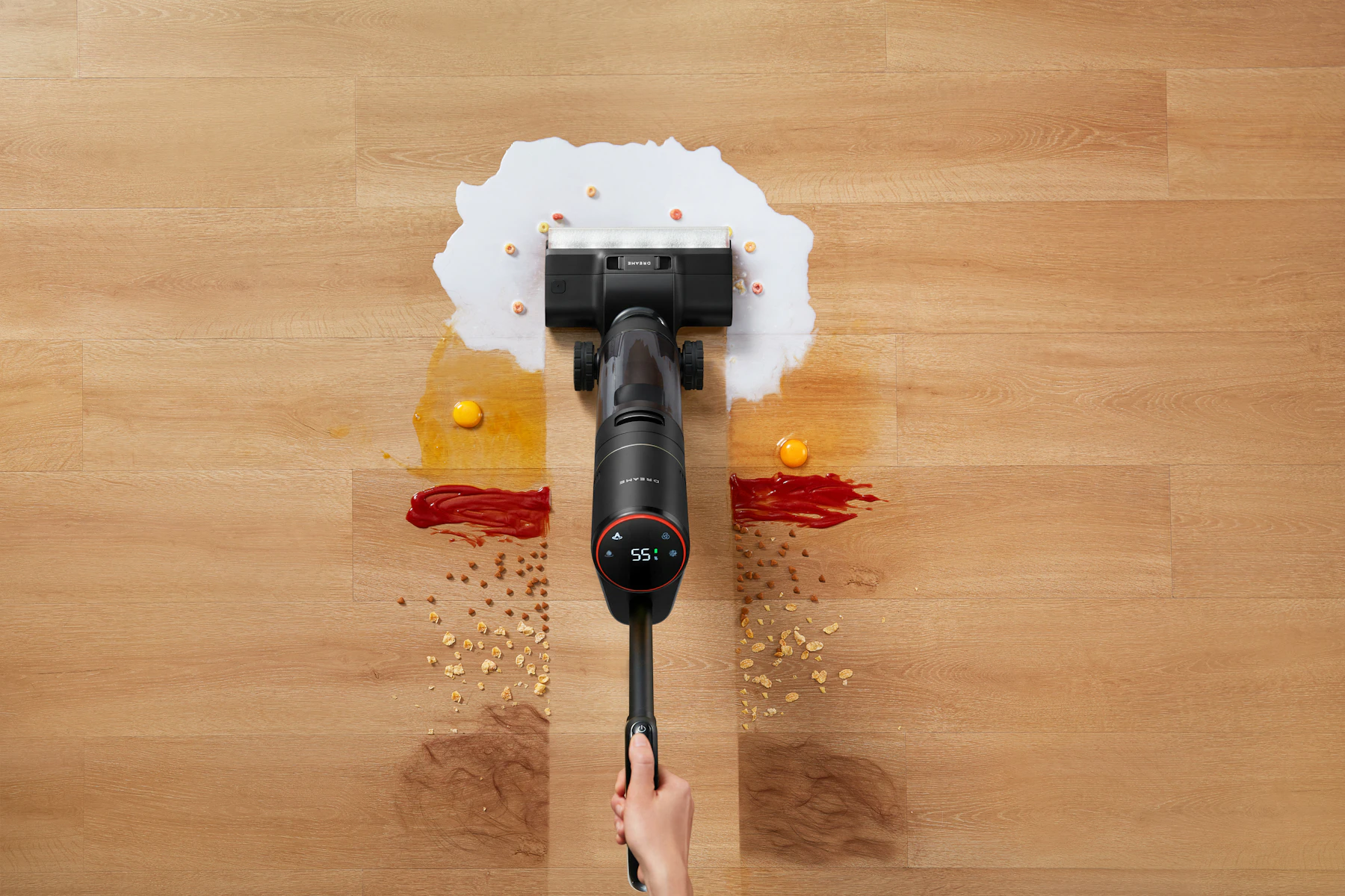 Cordless vacuum cleaning up debris on a wooden floor