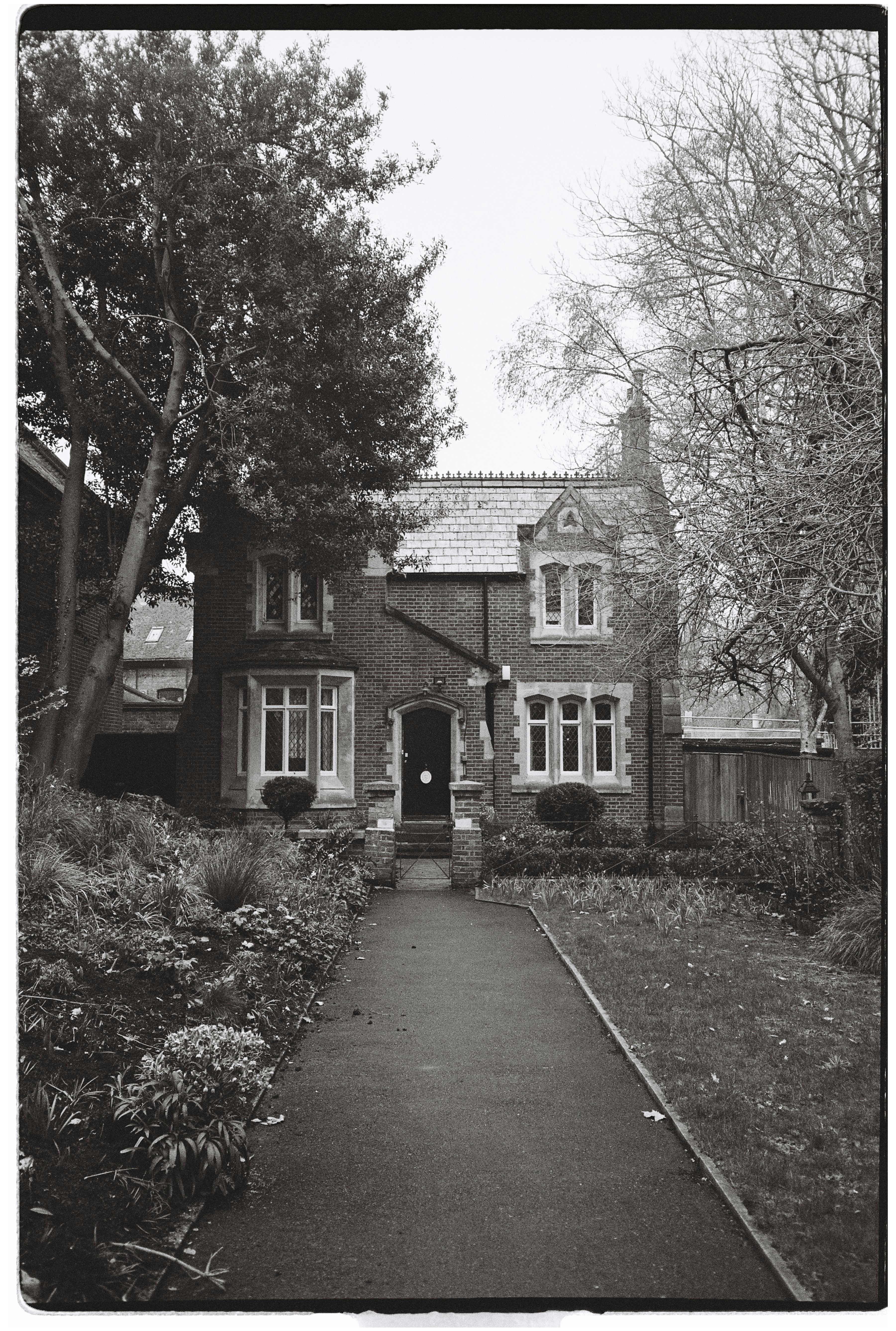 A brick house with a garden and pathway
