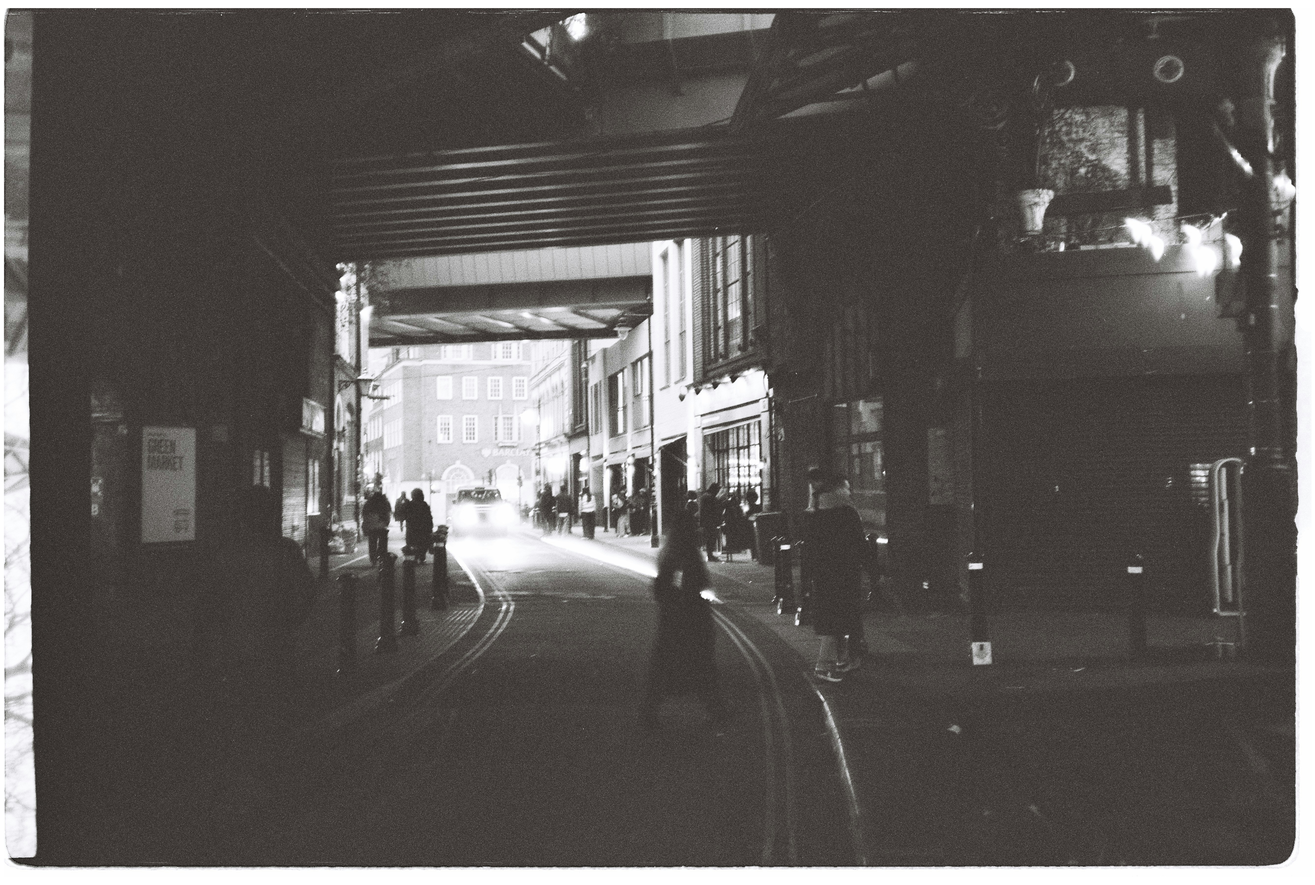 Street scene at night with people walking