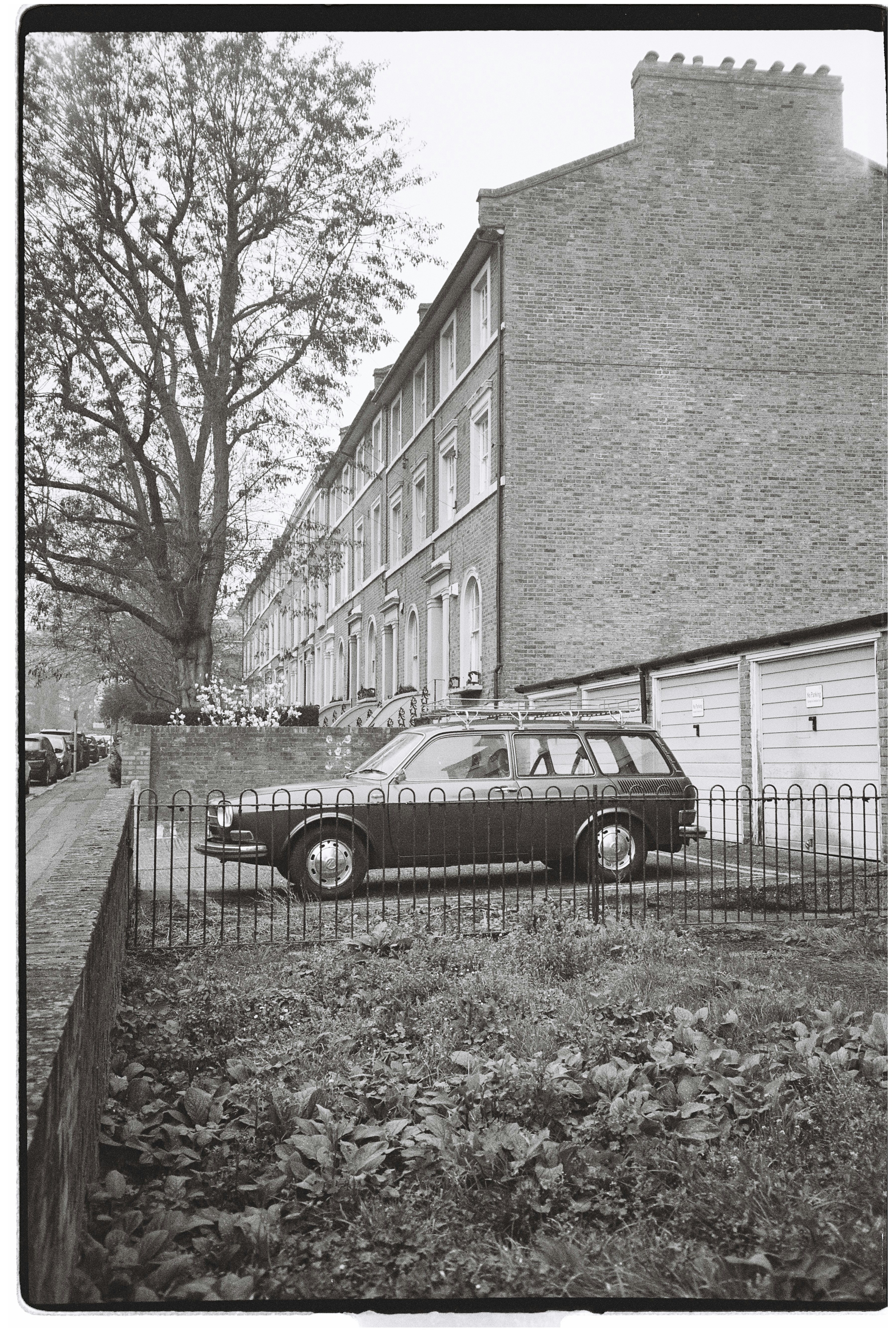 Station wagon parked in front of terraced houses