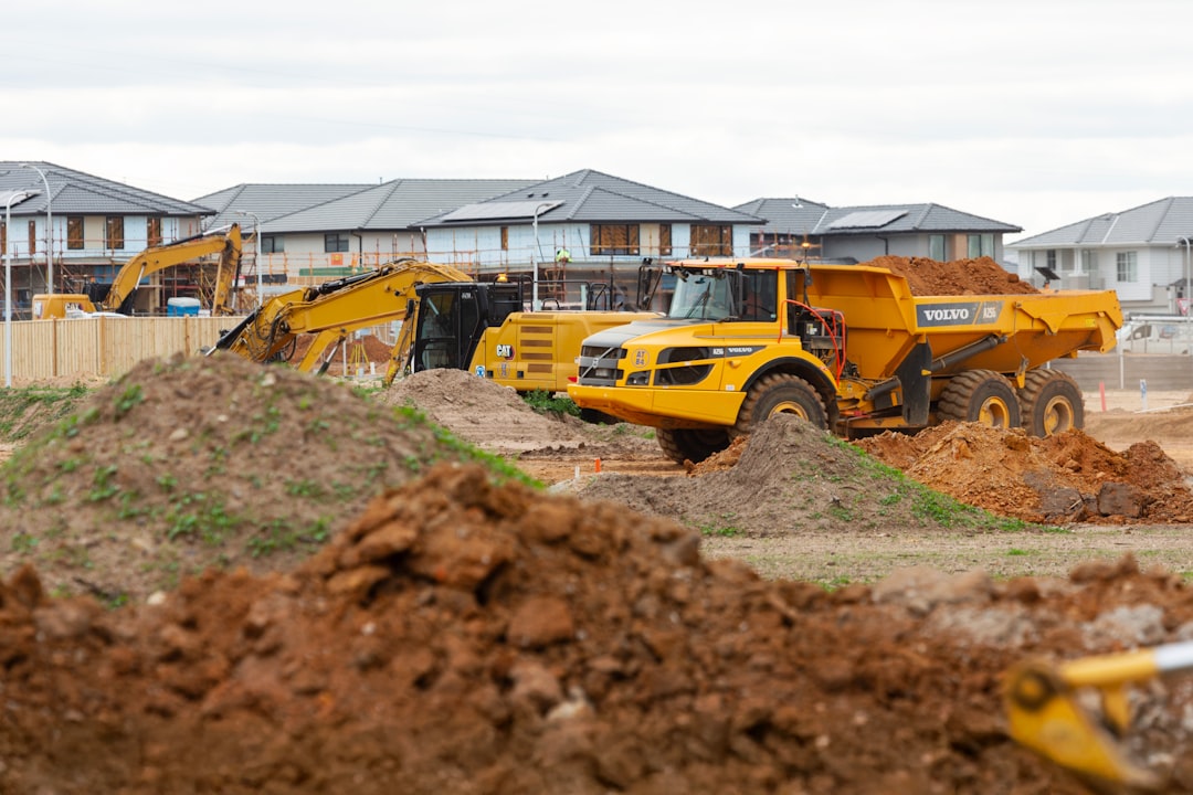Heavy machinery and excavator grading residential land Heavy machinery and excavator grading residential land