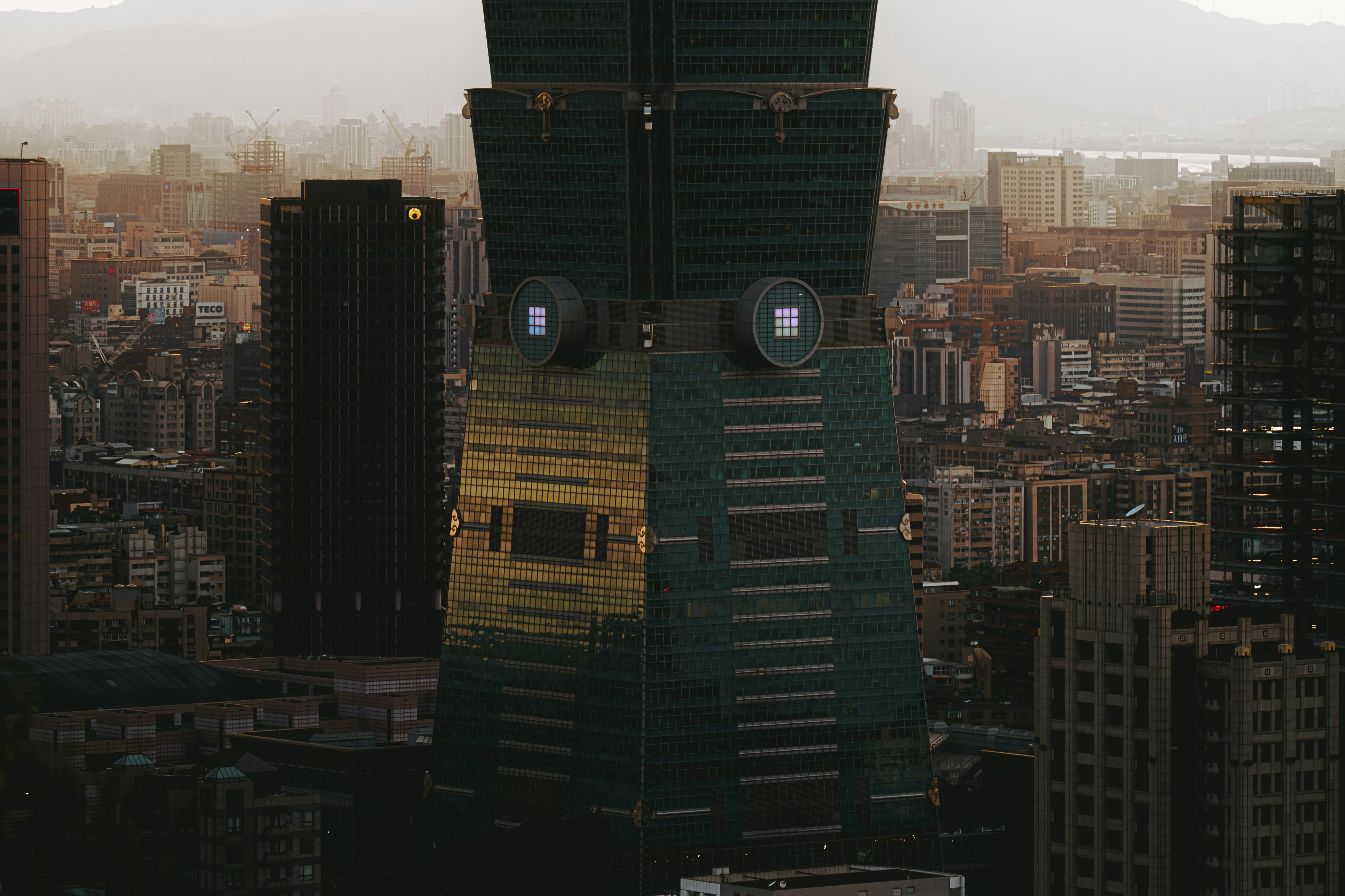 Tall skyscraper building in a city at dusk