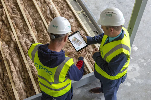 Engineers reviewing a system design on a tablet