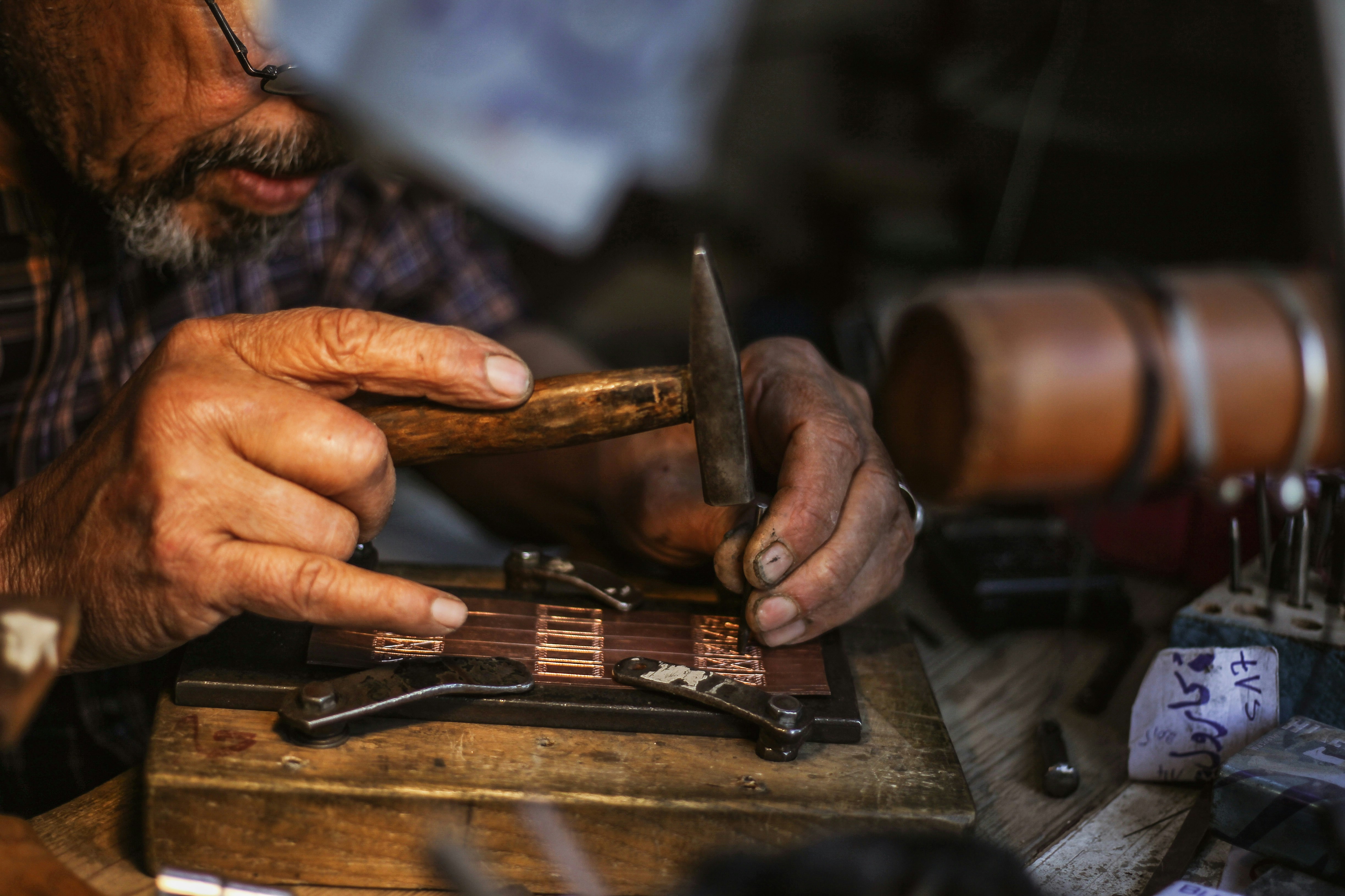 A man crafts souvenirs in Djerbahood, located in Djerba, Tunisia, which carries deep traces of history with its narrow streets, traditional architecture, and historic buildings, captivating its visitors on May 02, 2026.