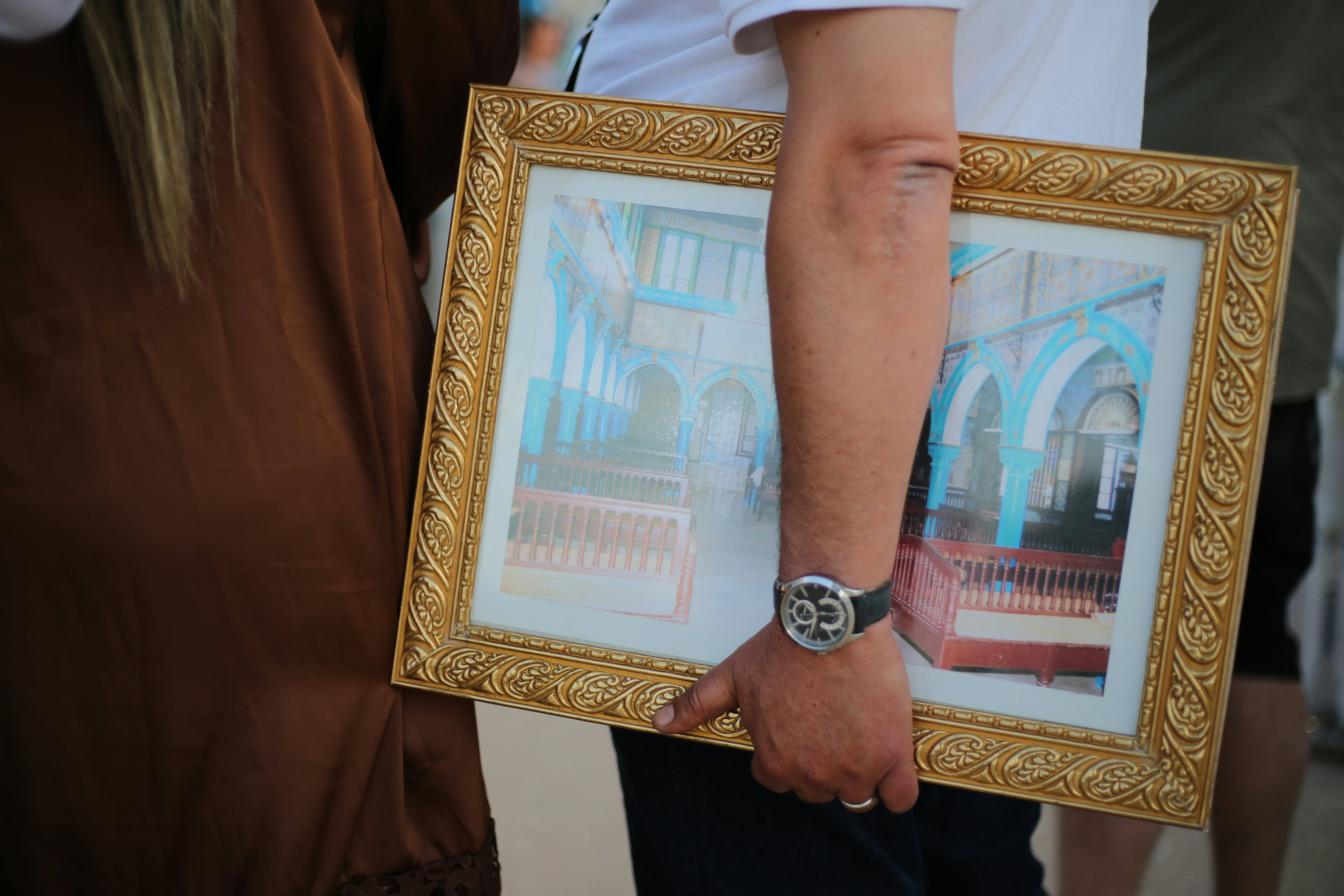 A close-up shot of a distraught mother's hands clasped together, perhaps holding a framed photo of her missing child, conveying pain and hope.