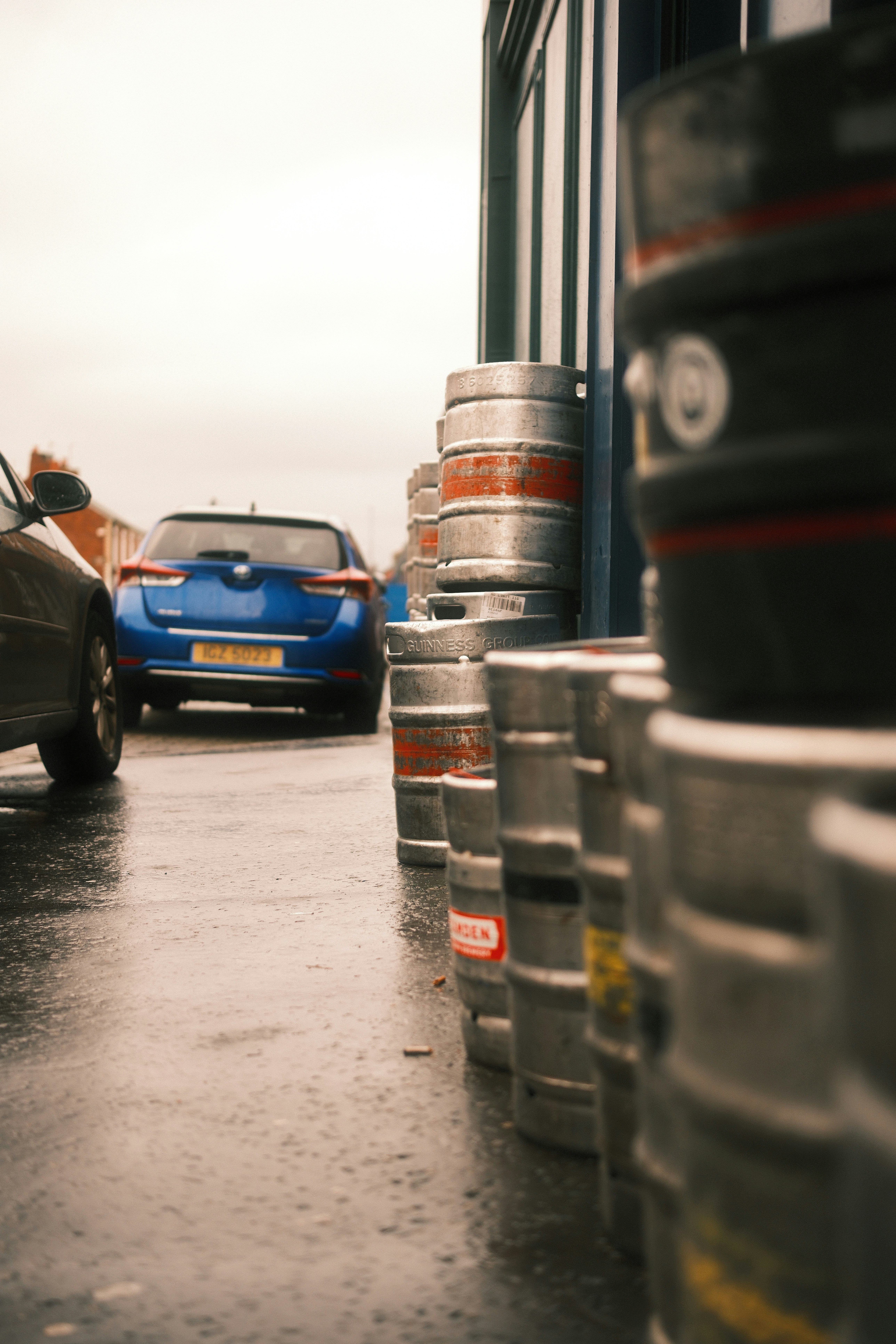 Metal beer kegs lined up outside a building