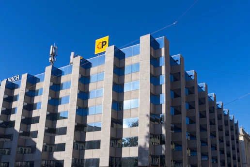 Modern office building with blue sky and yellow sign