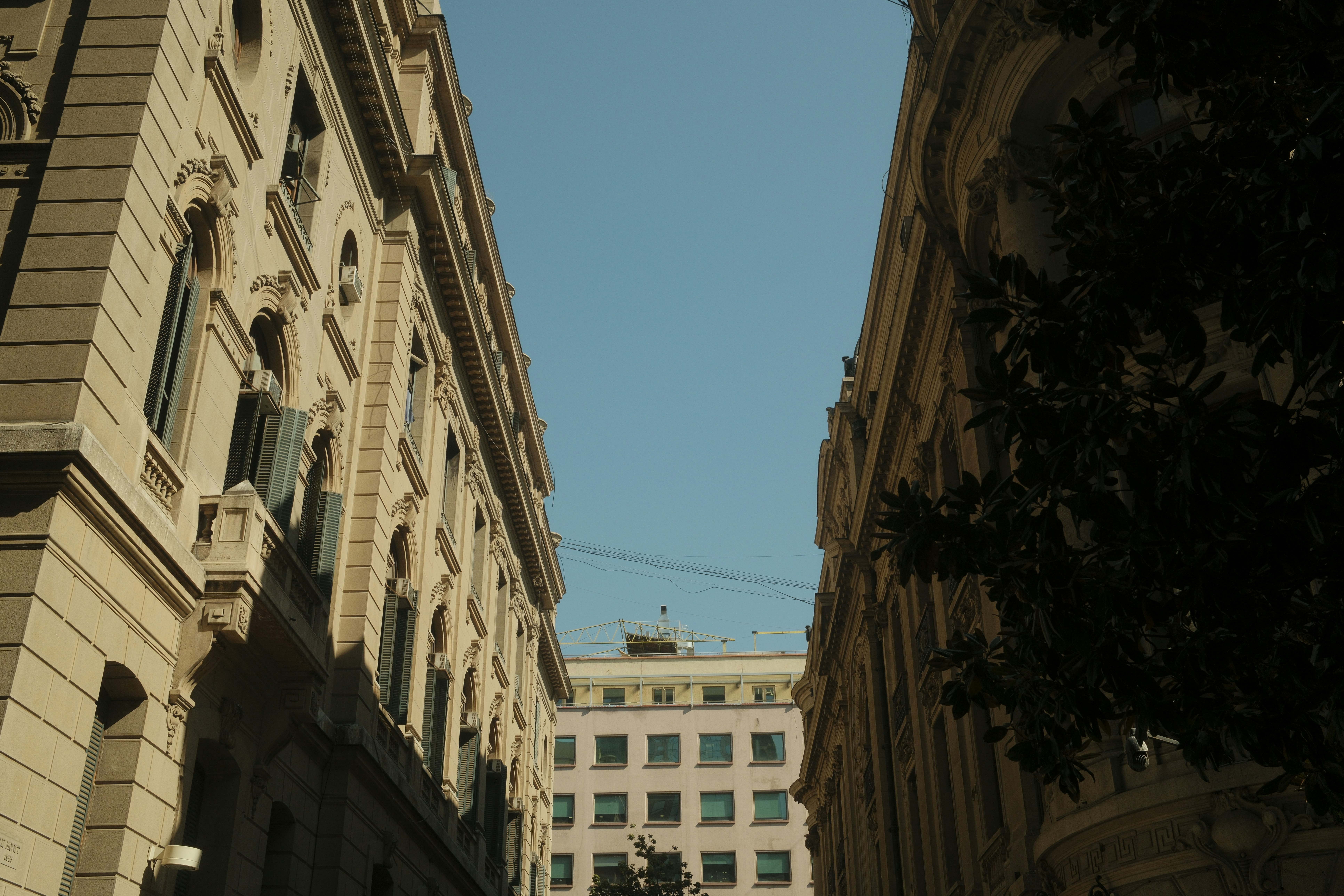 Buildings framing a clear blue sky