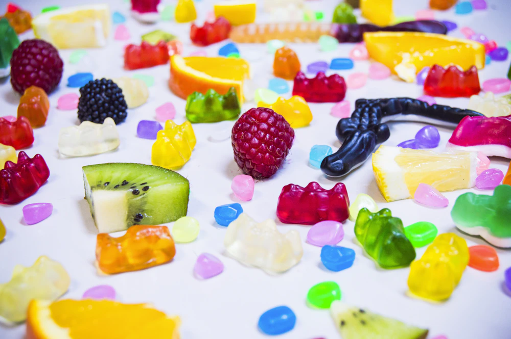 An assortment of gummies and fruit; application illustration
