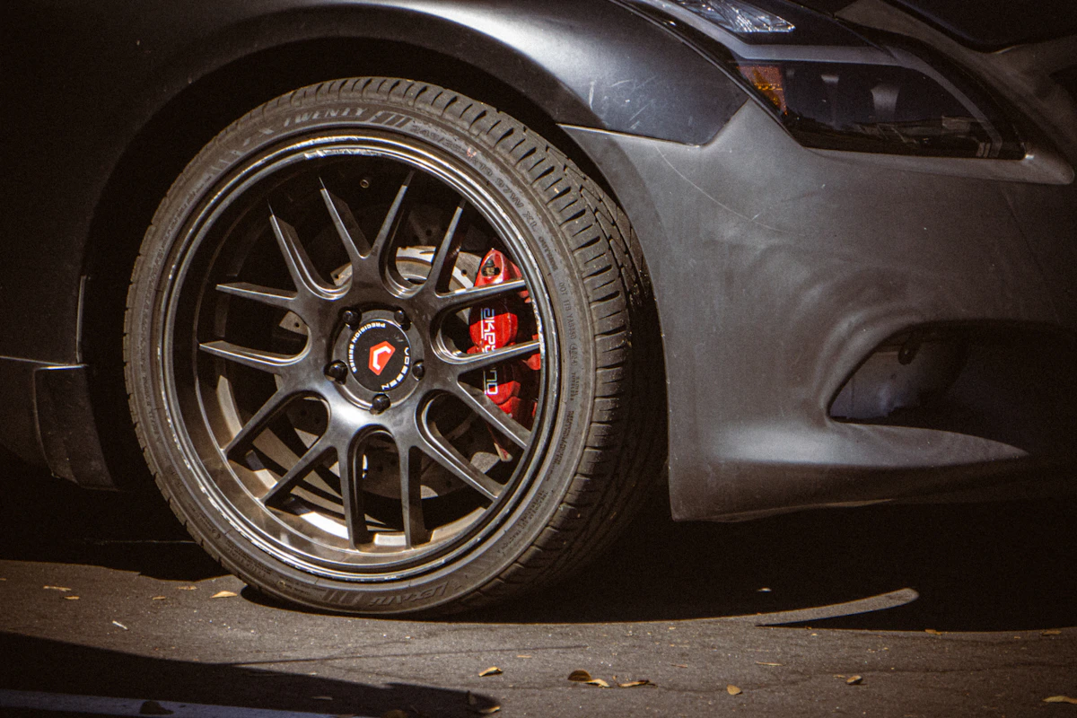Close-up of a car wheel and brake caliper during a brake and suspension inspection