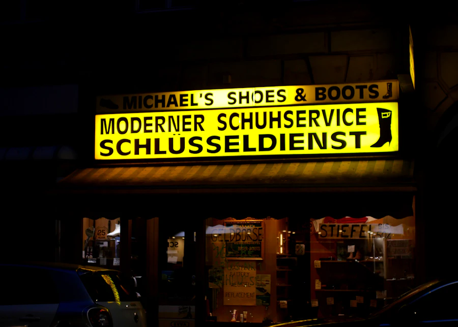 Lit shop sign over a storefront at night