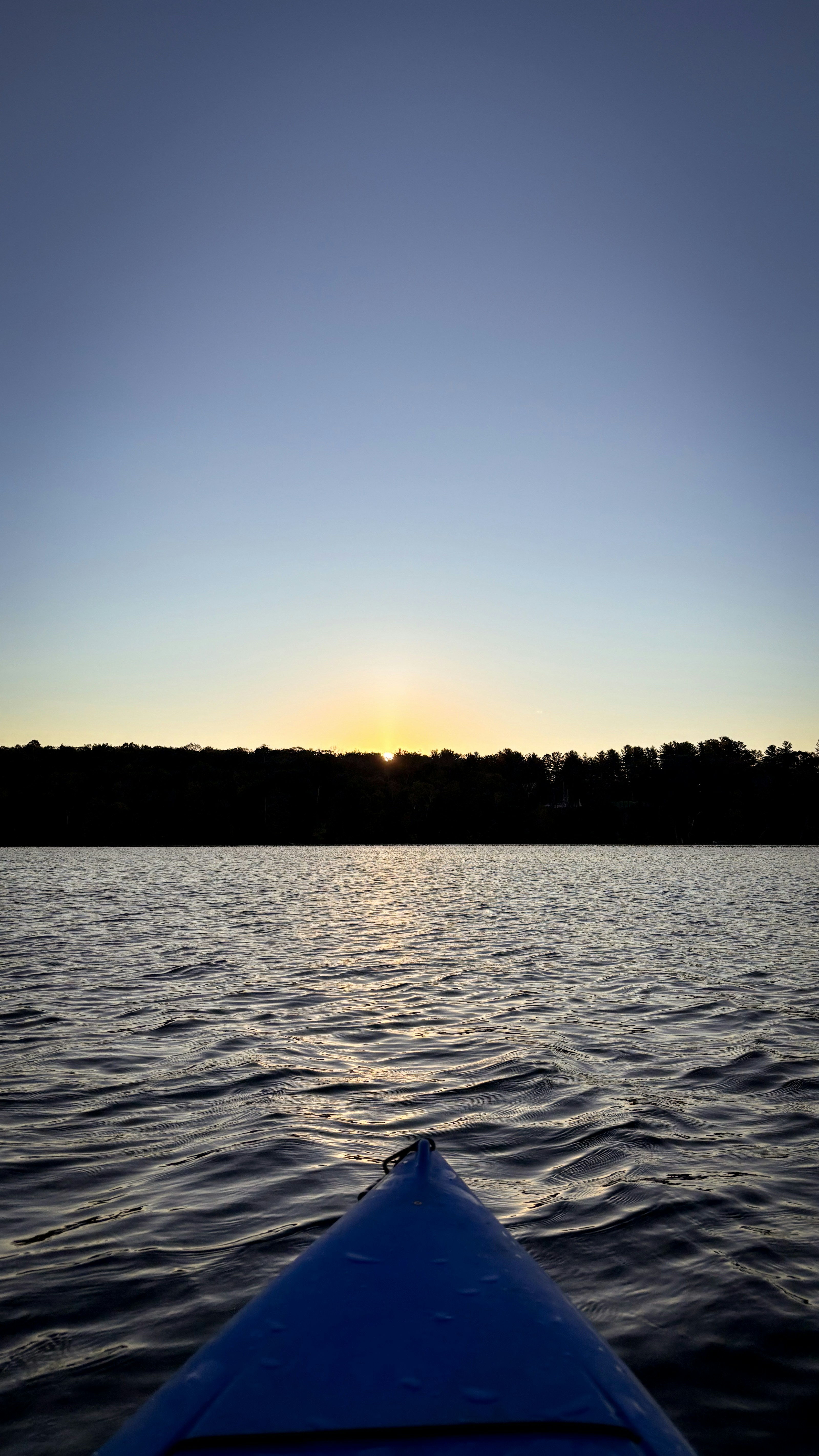 Kayaking on a calm lake at sunset