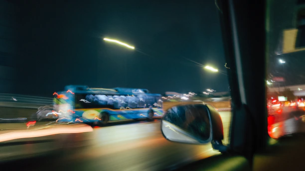 Bus driving on a highway at night with motion blur