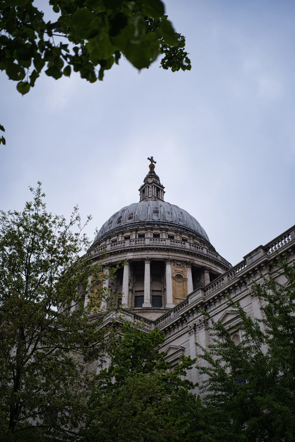 Majestic stone building with dome and columns stands tall under overcast sky surroundings