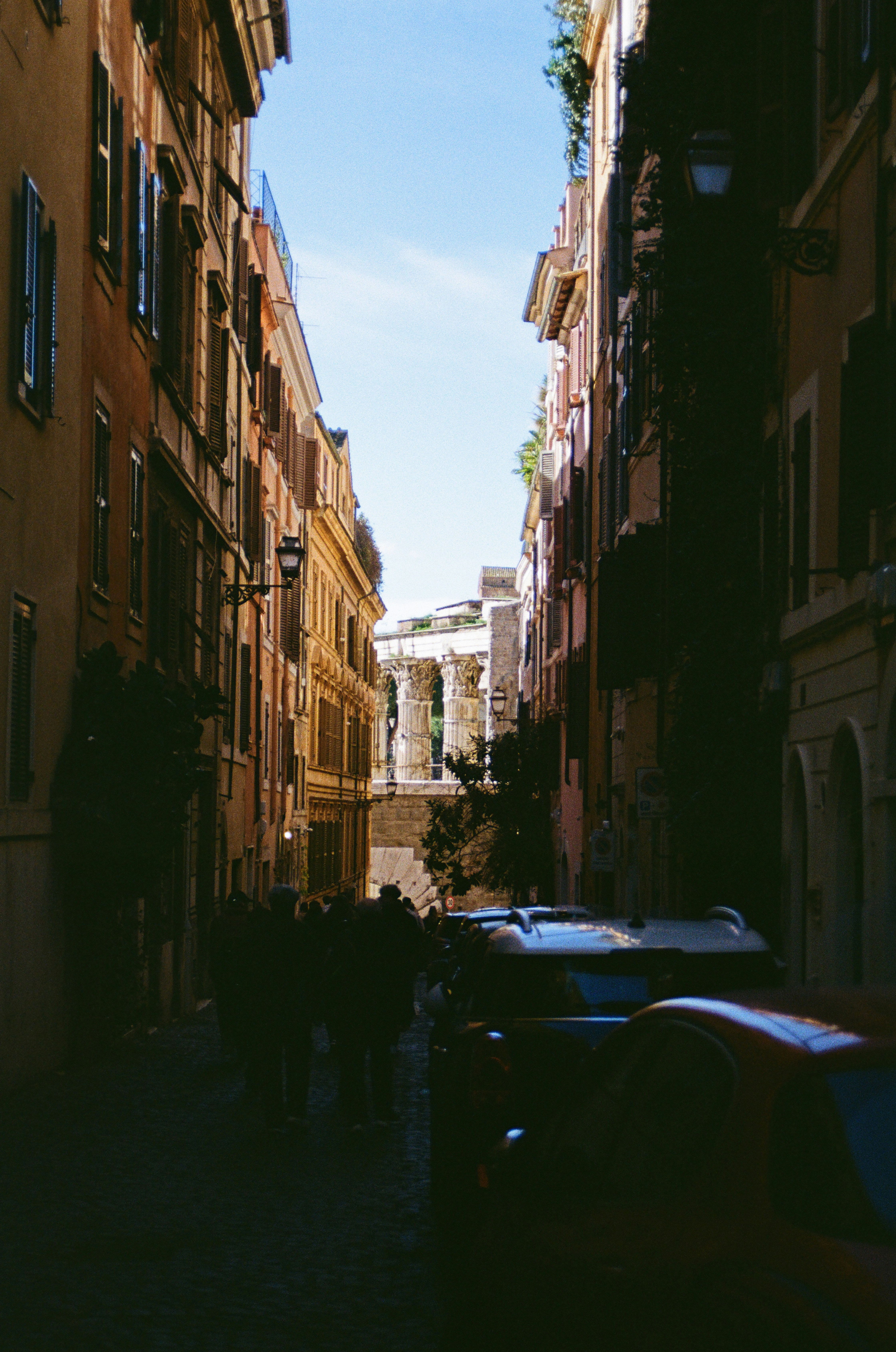 Narrow street with ancient ruins at the end