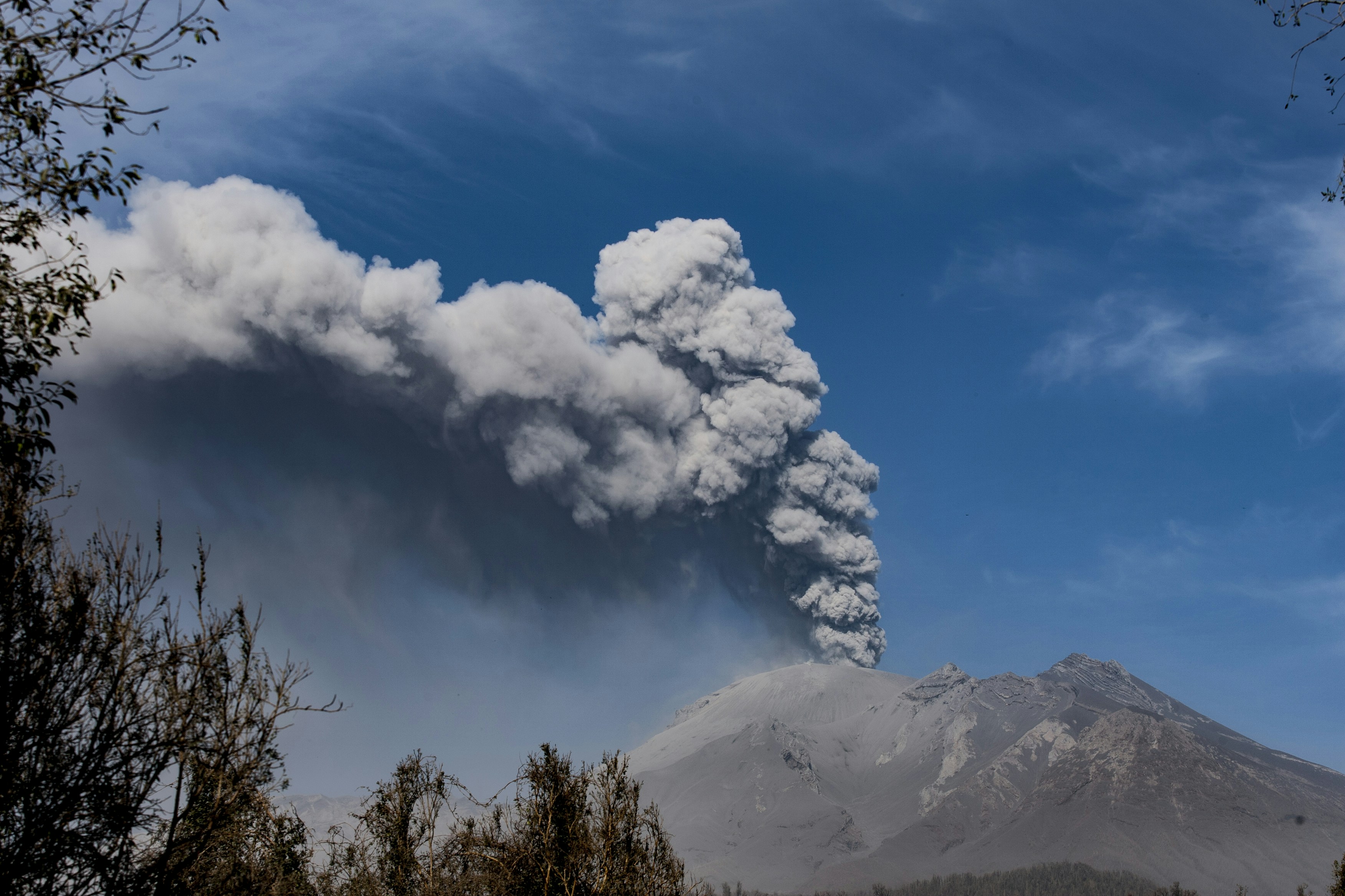 A volcano erupting with a large ash cloud