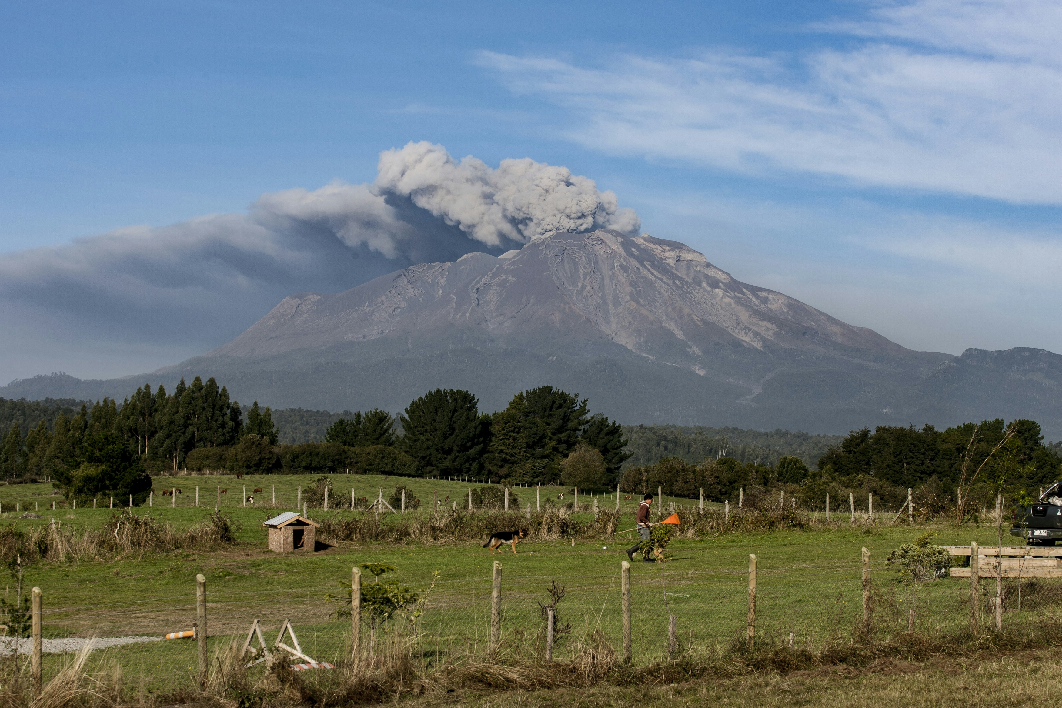 A volcano erupts with smoke billowing into the sky.