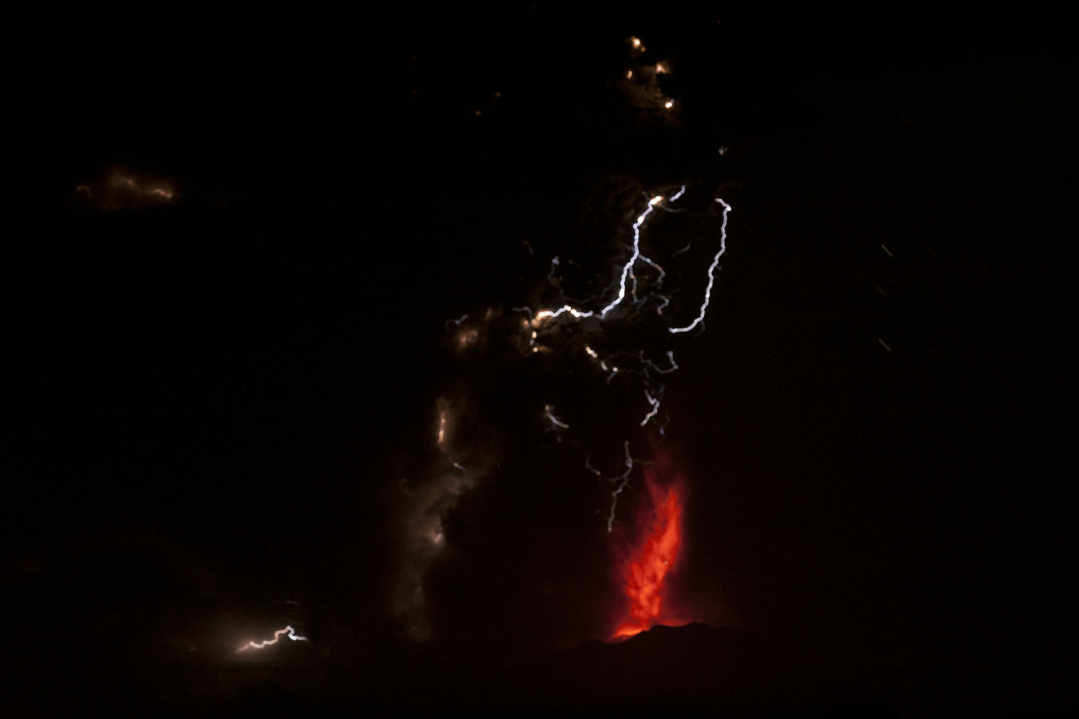 Volcanic eruption with lightning in dark night
