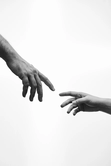 Two hands reaching towards each other
