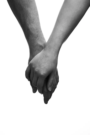 Two hands clasped together in a white background
