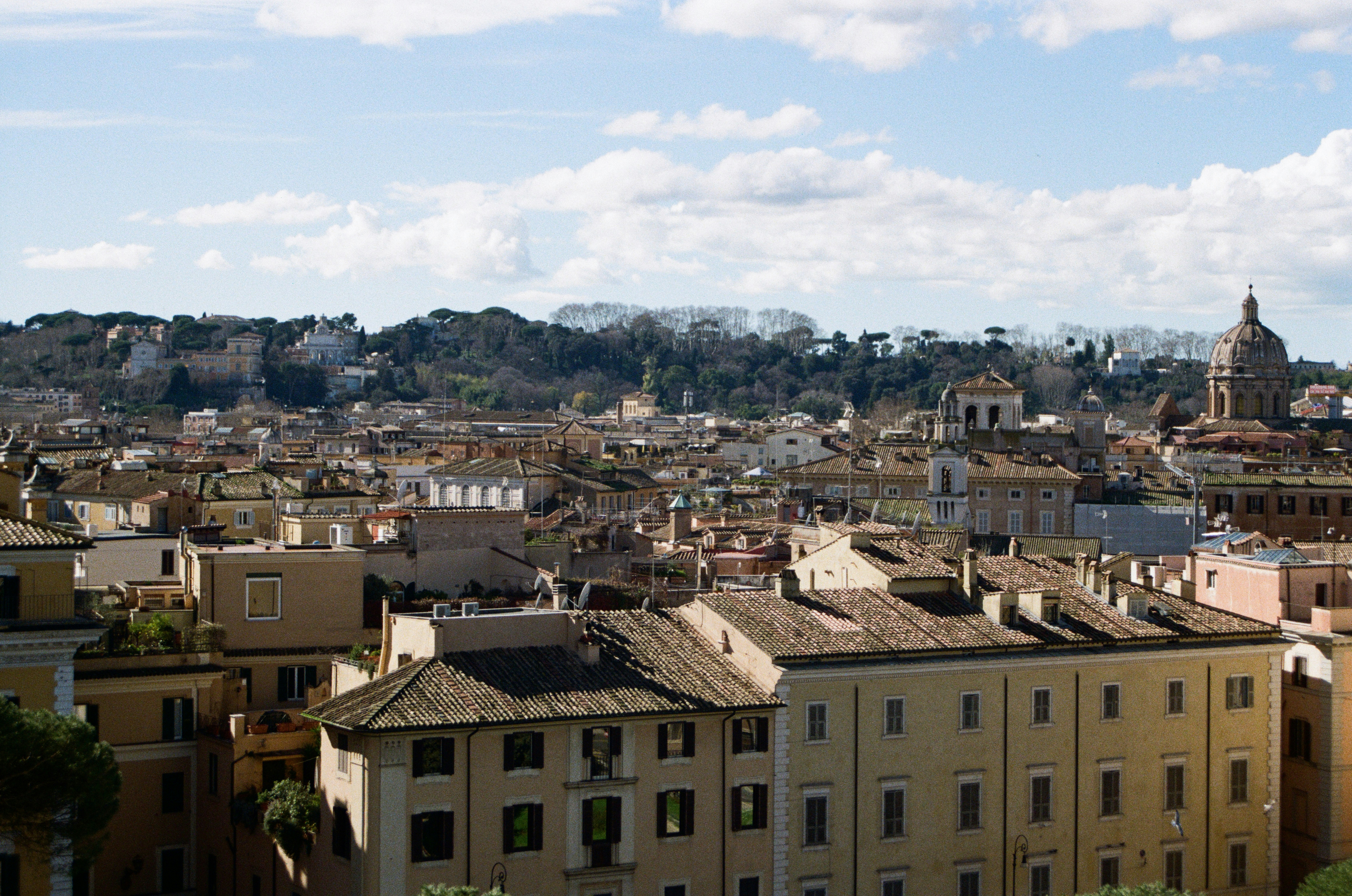 Rooftops of buildings in a european city with a dome.