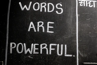 Words are powerful written on a blackboard.