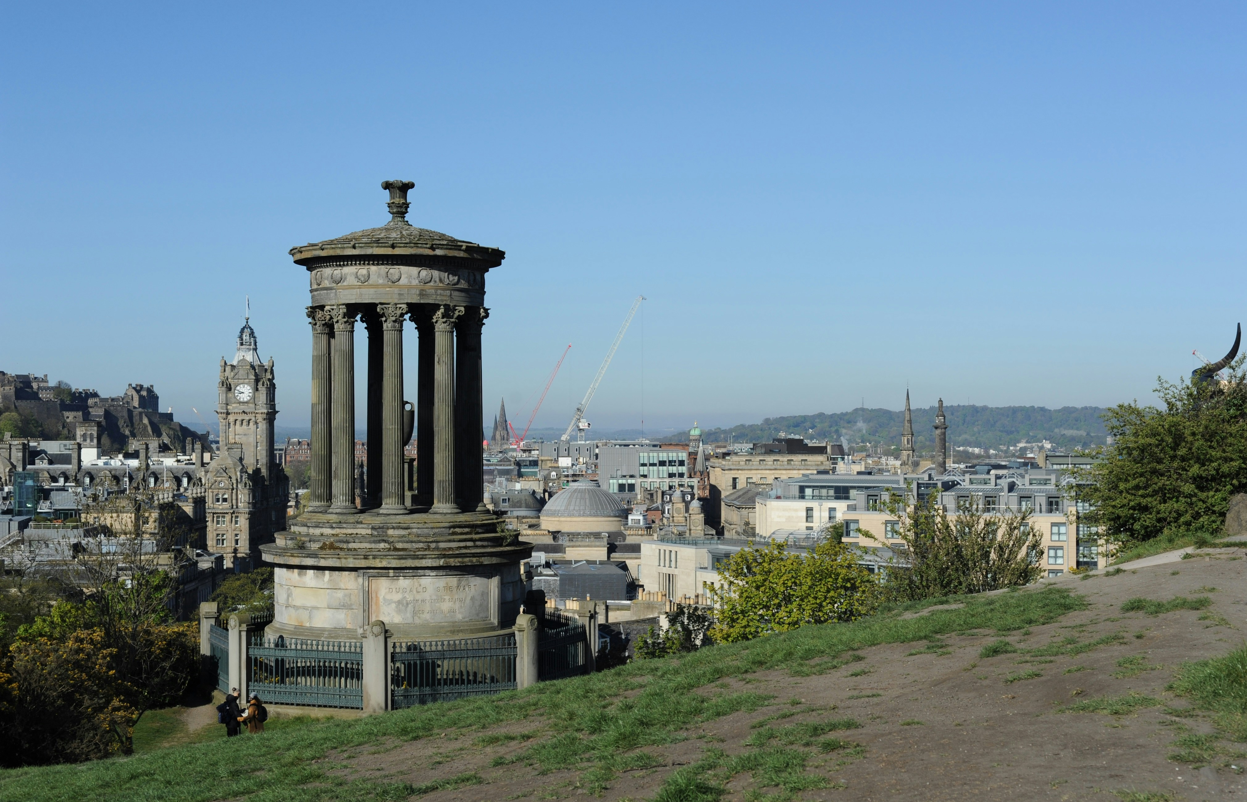 Monument overlooks a cityscape on a sunny day