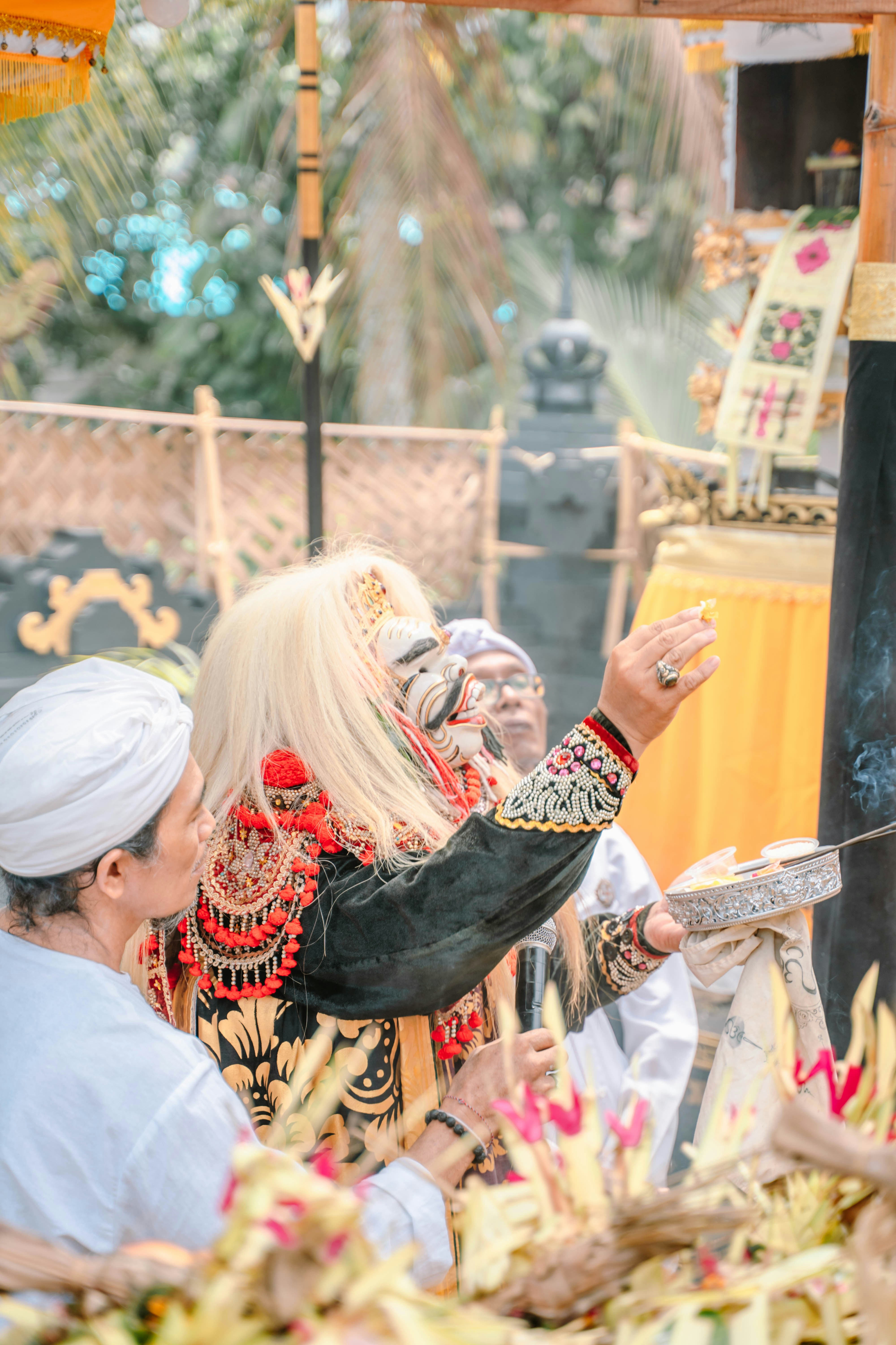 Person in elaborate costume performs a ritual