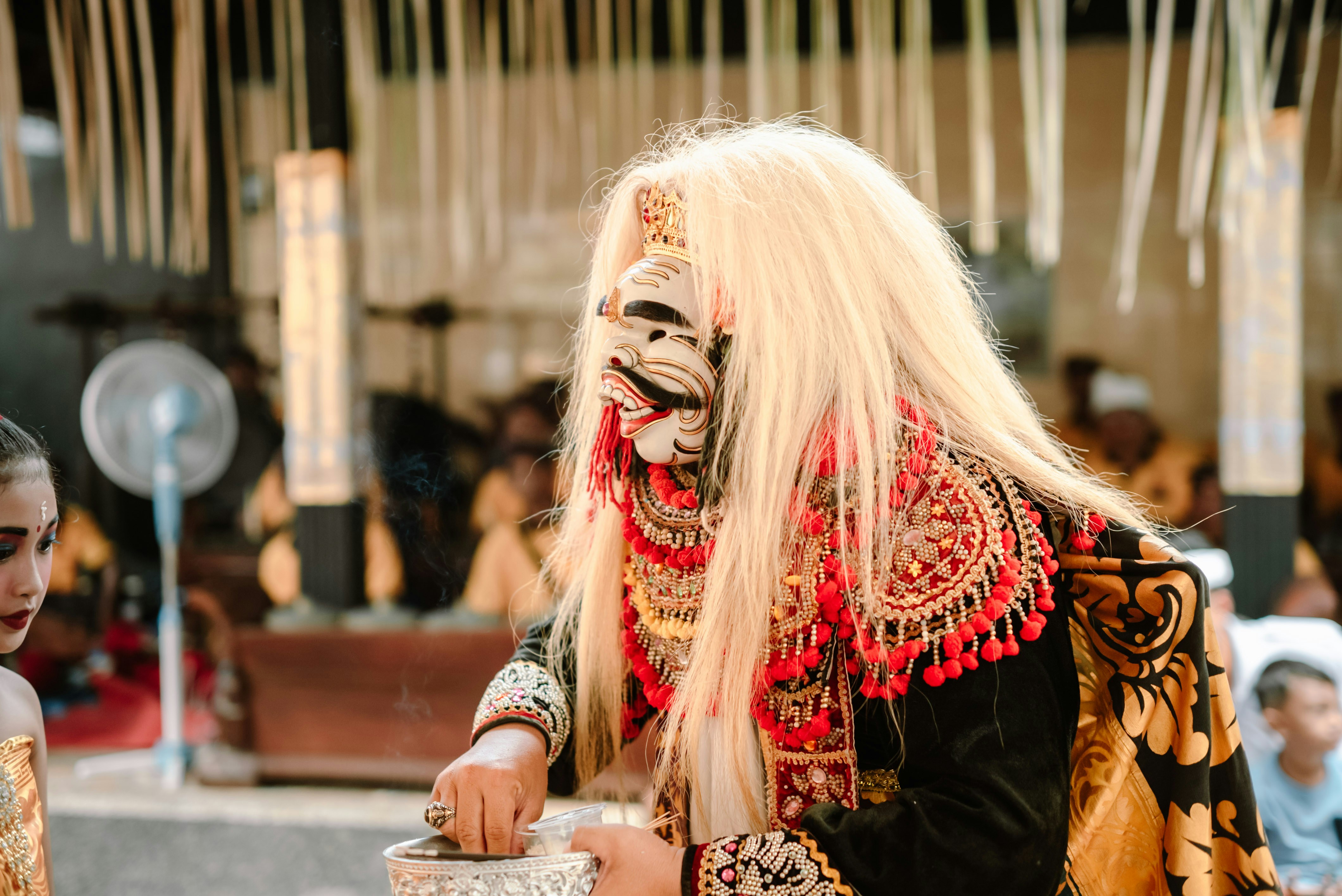 Performer in elaborate mask and costume during a traditional dance.