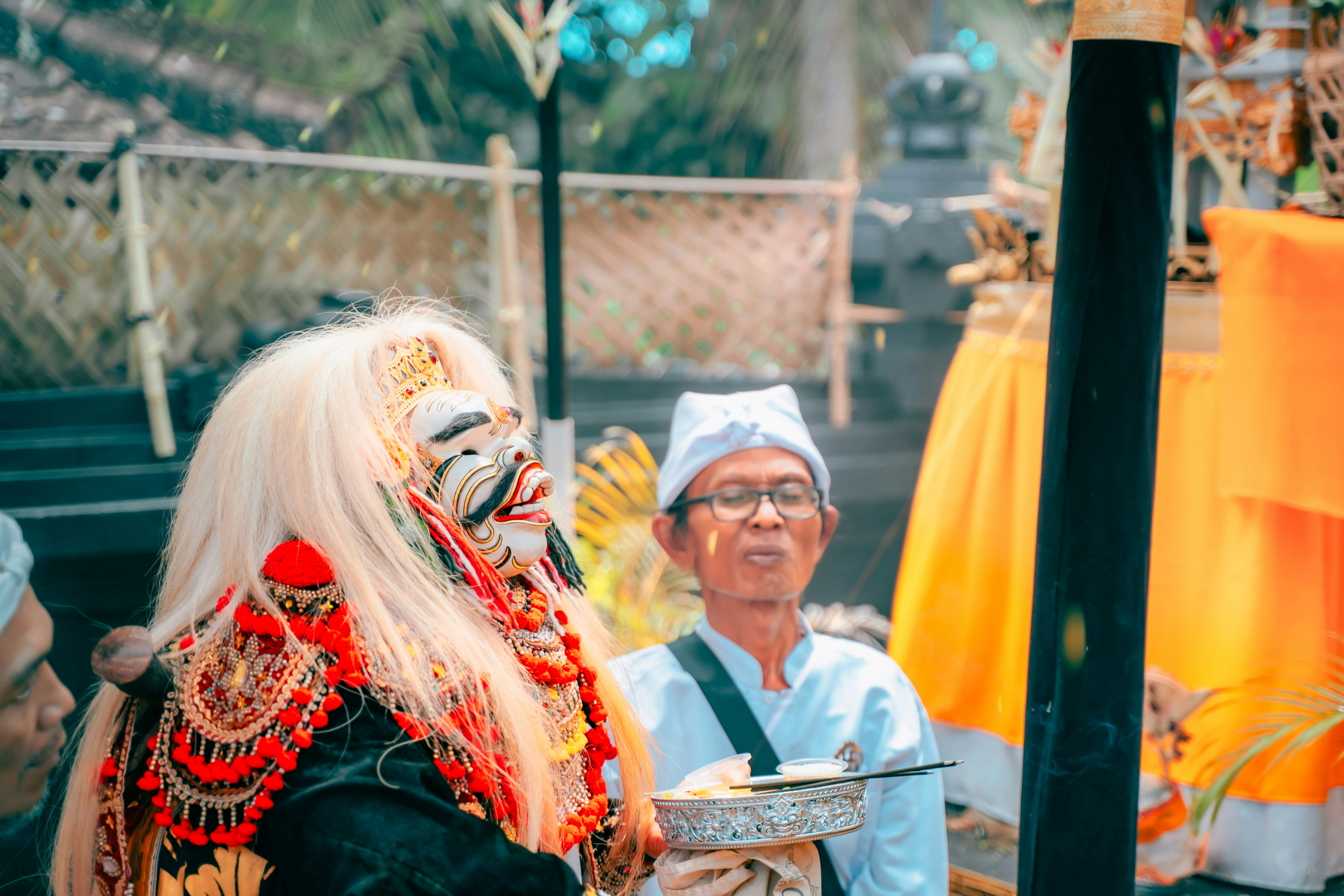 A person in a traditional balinese mask and costume.
