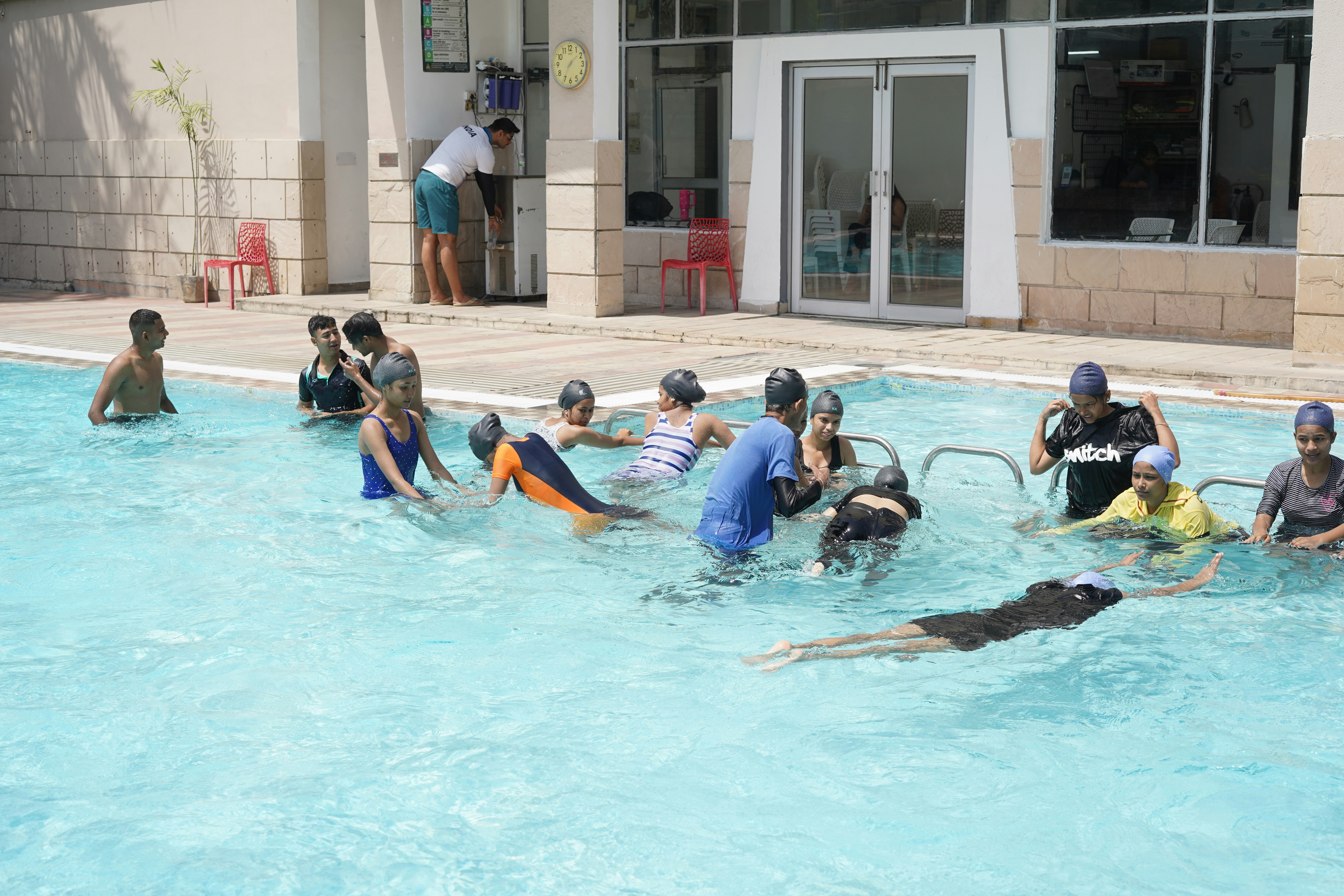 Children learning to swim in a pool