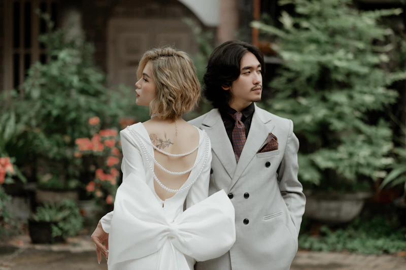 chic couple posing back to back